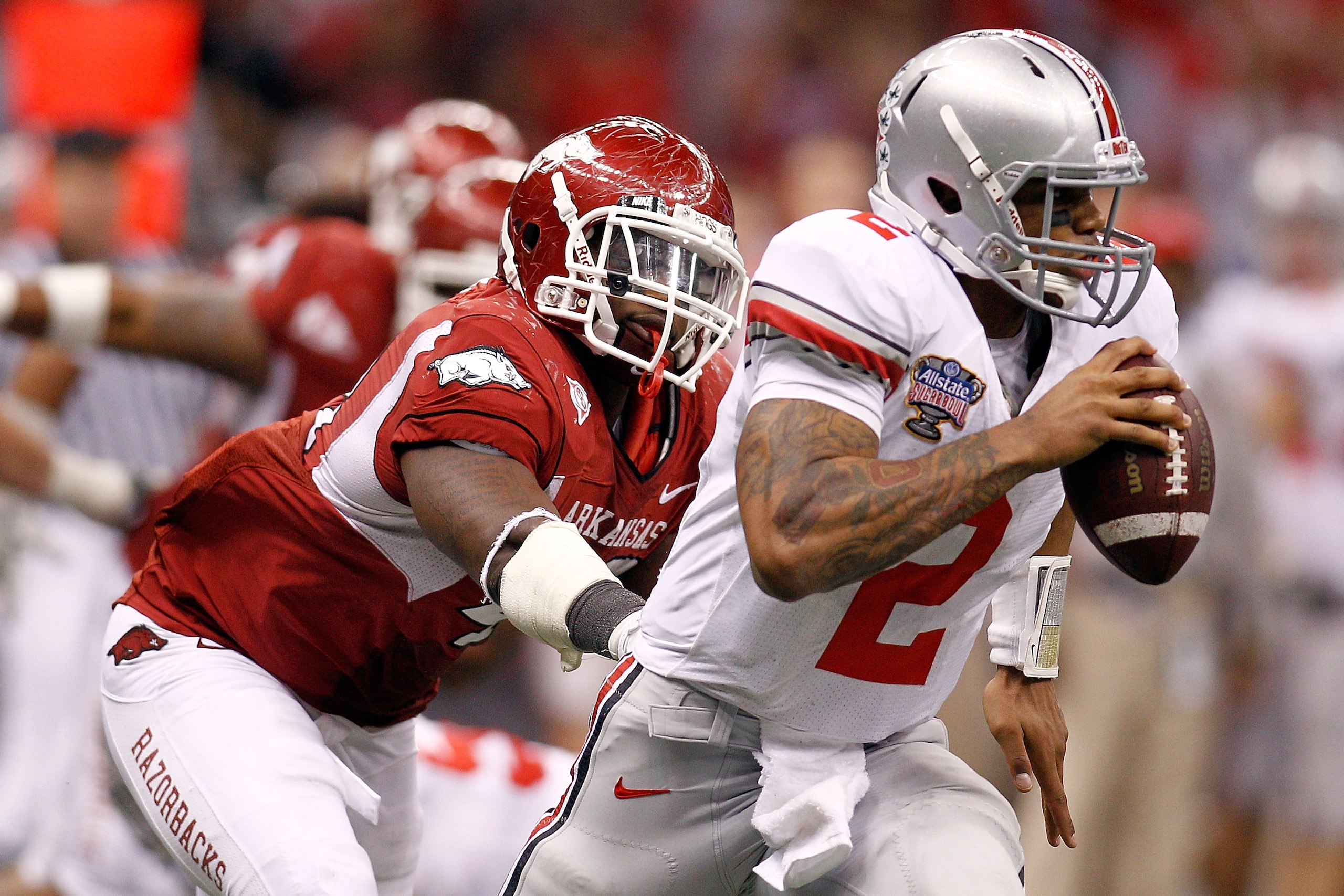NEW ORLEANS, LA - JANUARY 04: Quarterback Terrelle Pryor #2 of the Ohio State Buckeyes avoids a rush from Tenarius Wright #43 of the Arkansas Razorbacks in the fourth quarter during the Allstate Sugar Bowl at the Louisiana Superdome on January 4, 2011 in NEW ORLEANS, LA - JANUARY 04: Quarterback Terrelle Pryor #2 of the Ohio State Buckeyes avoids a rush from Tenarius Wright #43 of the Arkansas Razorbacks in the fourth quarter during the Allstate Sugar Bowl at the Louisiana Superdome on January 4, 2011 in