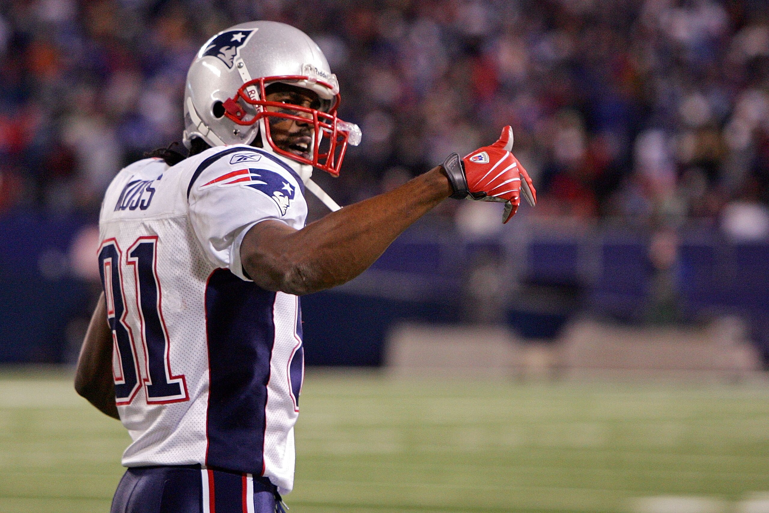 EAST RUTHERFORD, NJ - DECEMBER 29:  Randy Moss  #81 of the New England Patriots celebrates the touchdown of Laurence Maroney #39 in the fourth quarter against  the New York Giants on December 29, 2007 at Giants Stadium in East Rutherford, New Jersey.  (Ph