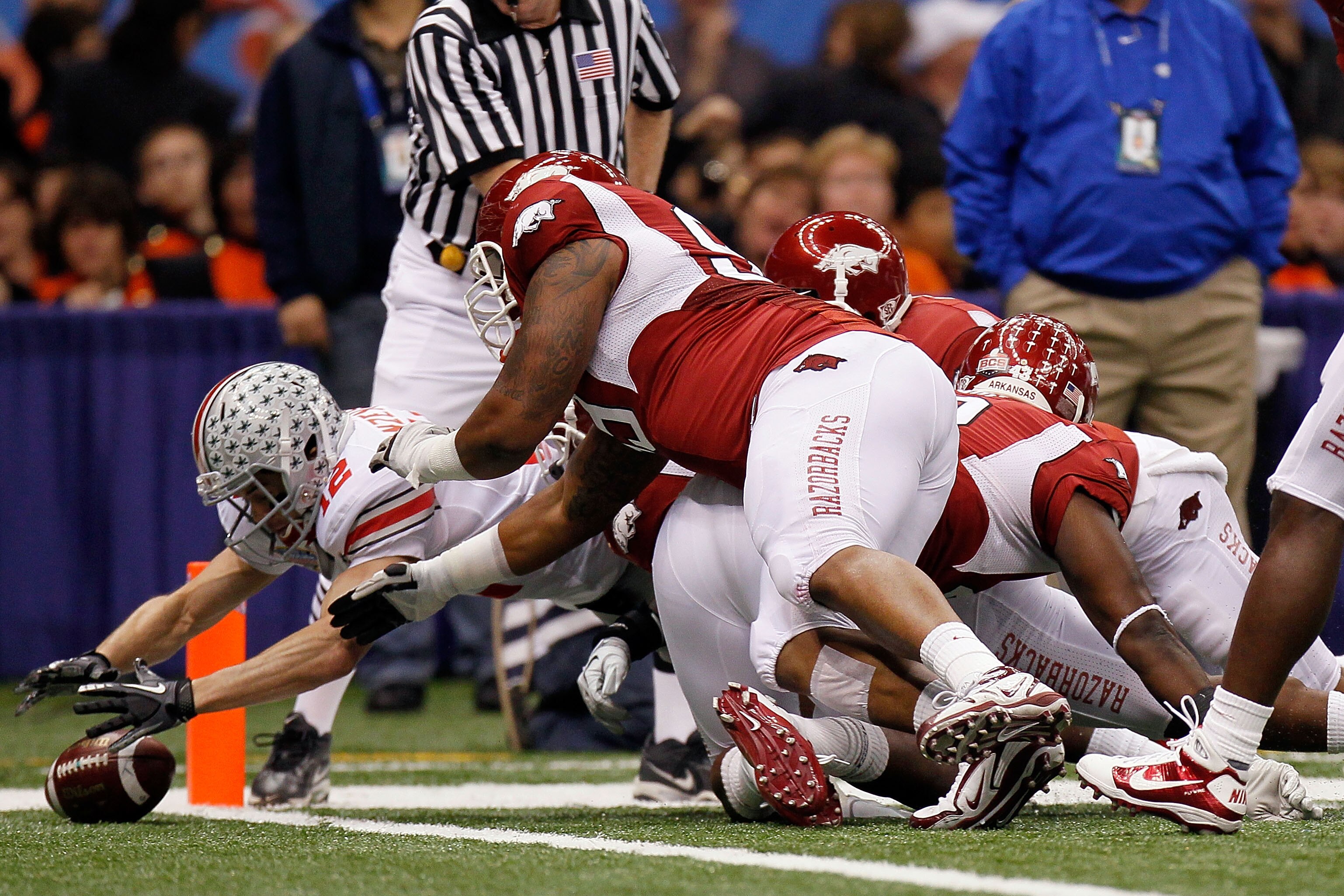 NEW ORLEANS, LA - JANUARY 04:  Dane Sanzenbacher #12 of the Ohio State Buckeyes recovers a Terrelle Pryor #2 fumble in the endzone for a touchdown in the first quarter against the Arkansas Razorbacks during the Allstate Sugar Bowl at the Louisiana Superdo