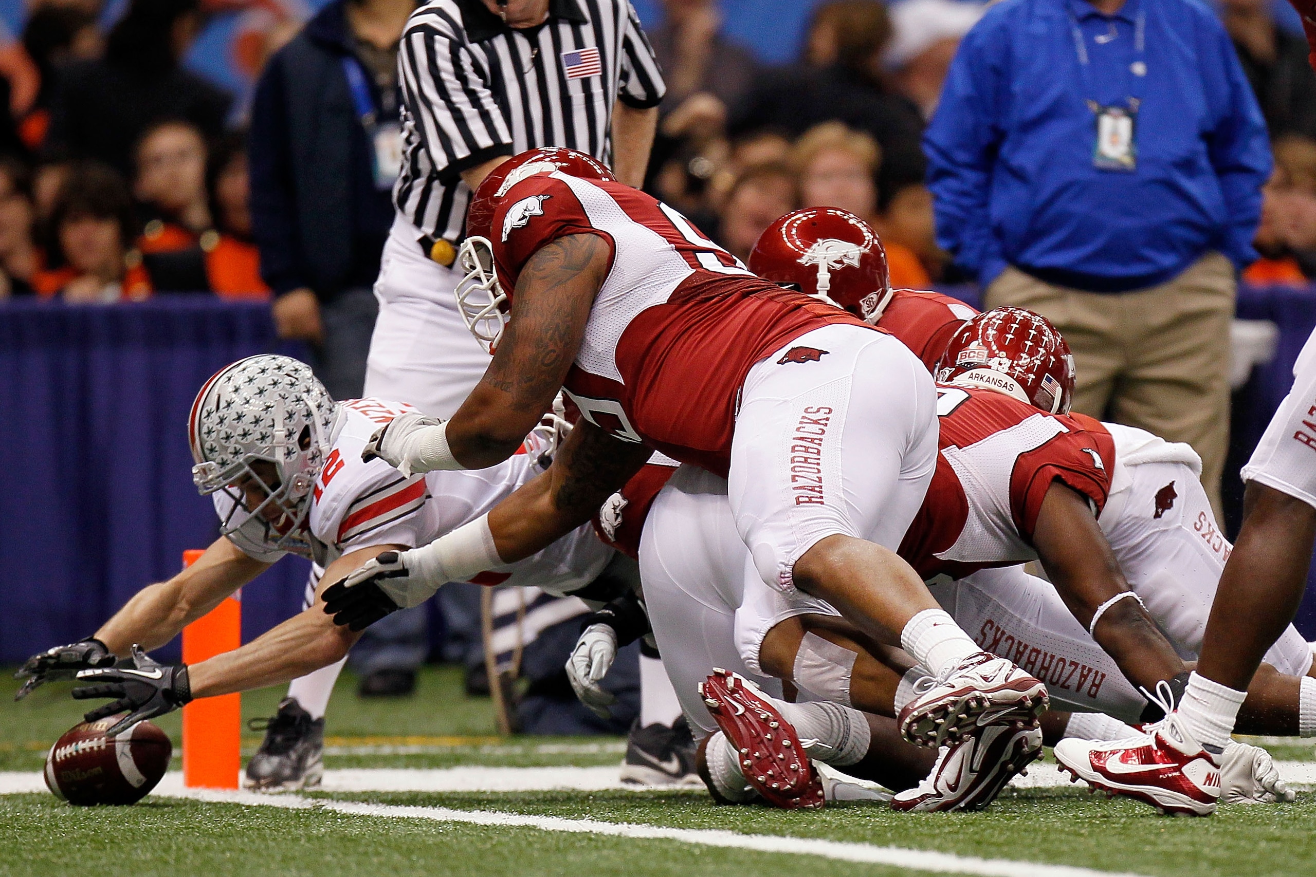NEW ORLEANS, LA - JANUARY 04: Dane Sanzenbacher #12 of the Ohio State Buckeyes recovers a Terrelle Pryor #2 fumble in the endzone for a touchdown in the first quarter against the Arkansas Razorbacks during the Allstate Sugar Bowl at the Louisiana Superdo NEW ORLEANS, LA - JANUARY 04: Dane Sanzenbacher #12 of the Ohio State Buckeyes recovers a Terrelle Pryor #2 fumble in the endzone for a touchdown in the first quarter against the Arkansas Razorbacks during the Allstate Sugar Bowl at the Louisiana Superdo