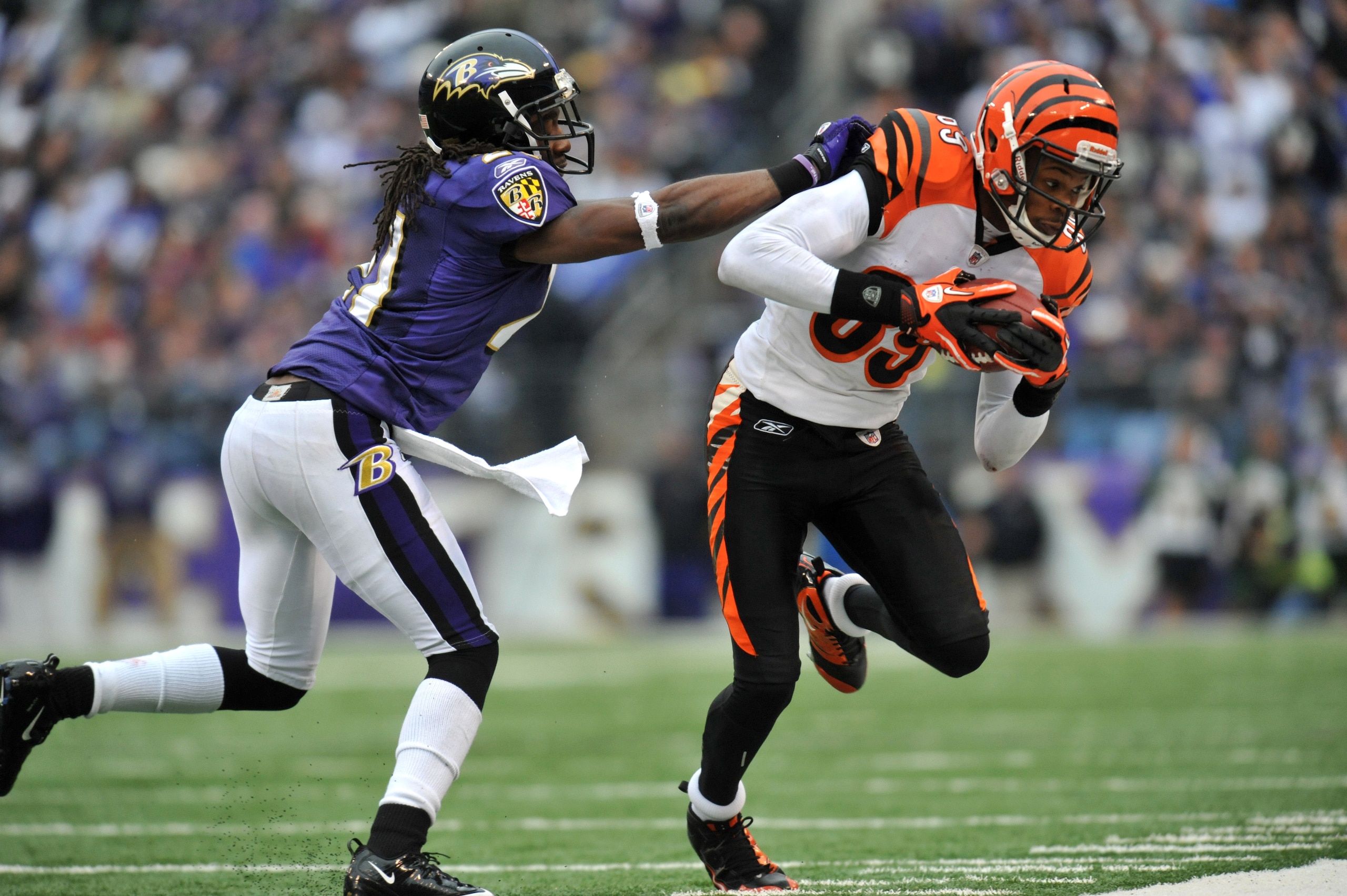 BALTIMORE, MD - JANUARY 2:  Jerome Simpson #89 of the Cincinnati Bengals runs the ball against Lardarius Webb #21 of the Baltimore Ravens at M&T Bank Stadium on January 2, 2011 in Baltimore, Maryland. The Ravens lead the Bengals 6-0 at the half. (Photo by
