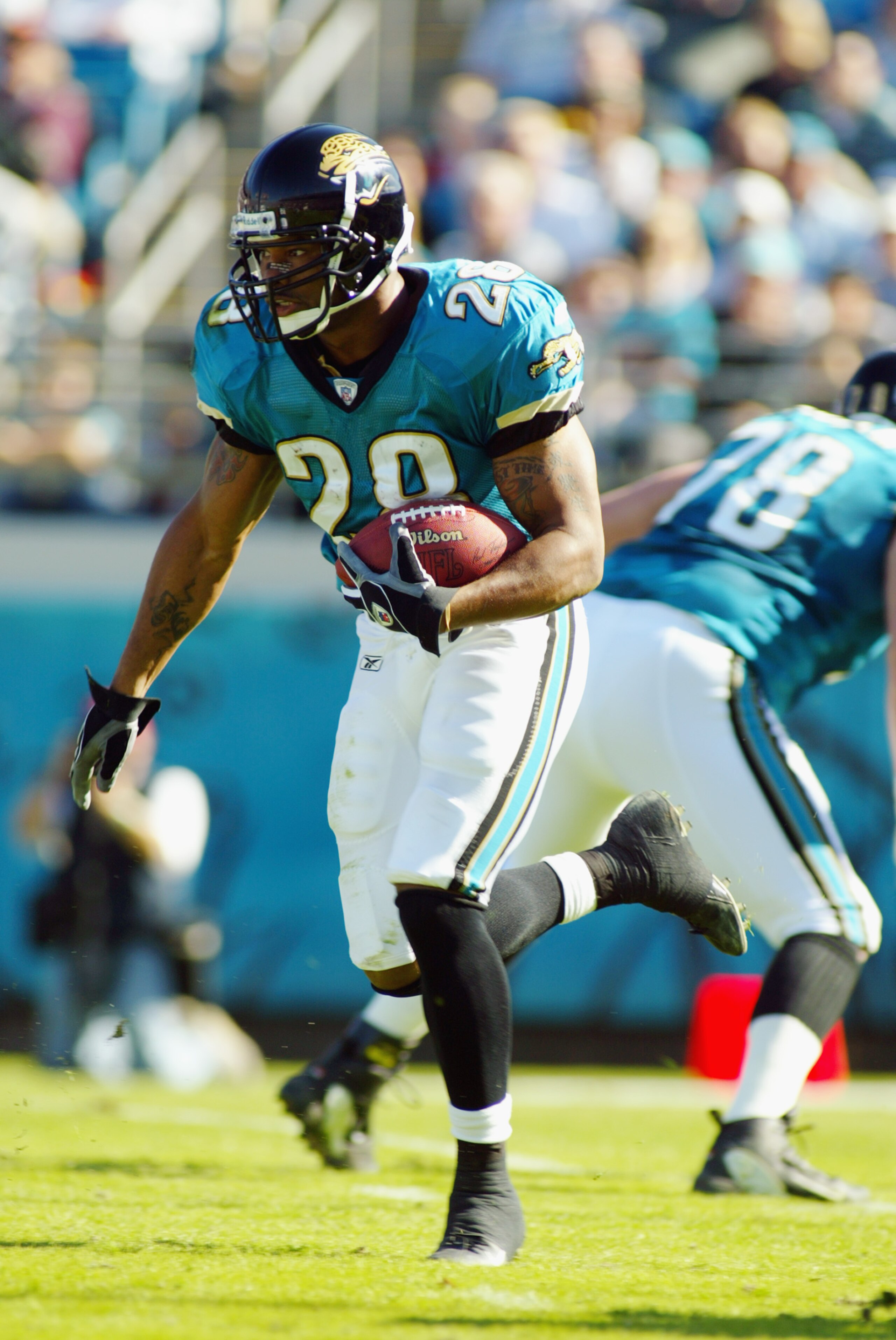 JACKSONVILLE, FL - DECEMBER 22:  Running back Fred Taylor #28 of the Jacksonville Jaguars carries the ball during the game against the Tennessee Titans at Alltel Stadium on December 22, 2002 in Jacksonville, Florida.  The Titans defeated the Jaguars 26-10