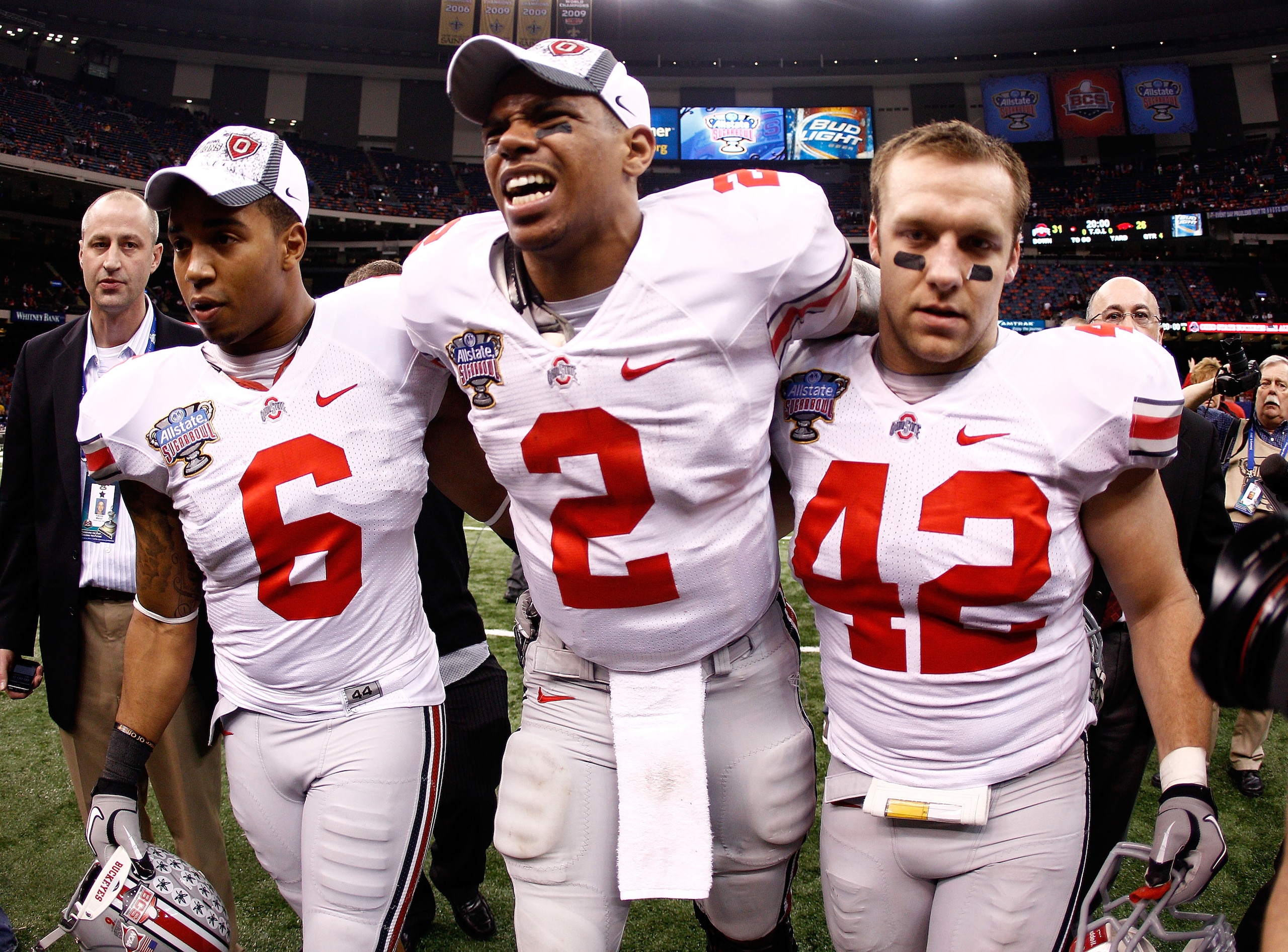 NEW ORLEANS, LA - JANUARY 04: (M) Quarterback Terrelle Pryor #2 of the Ohio State Buckeyes is helped off the field by teammates Etienne Sabino #6 and Andrew Sweat #42 after the Buckeyes 31-26 victory against the Arkansas Razorbacks during the Allstate Su NEW ORLEANS, LA - JANUARY 04: (M) Quarterback Terrelle Pryor #2 of the Ohio State Buckeyes is helped off the field by teammates Etienne Sabino #6 and Andrew Sweat #42 after the Buckeyes 31-26 victory against the Arkansas Razorbacks during the Allstate Su