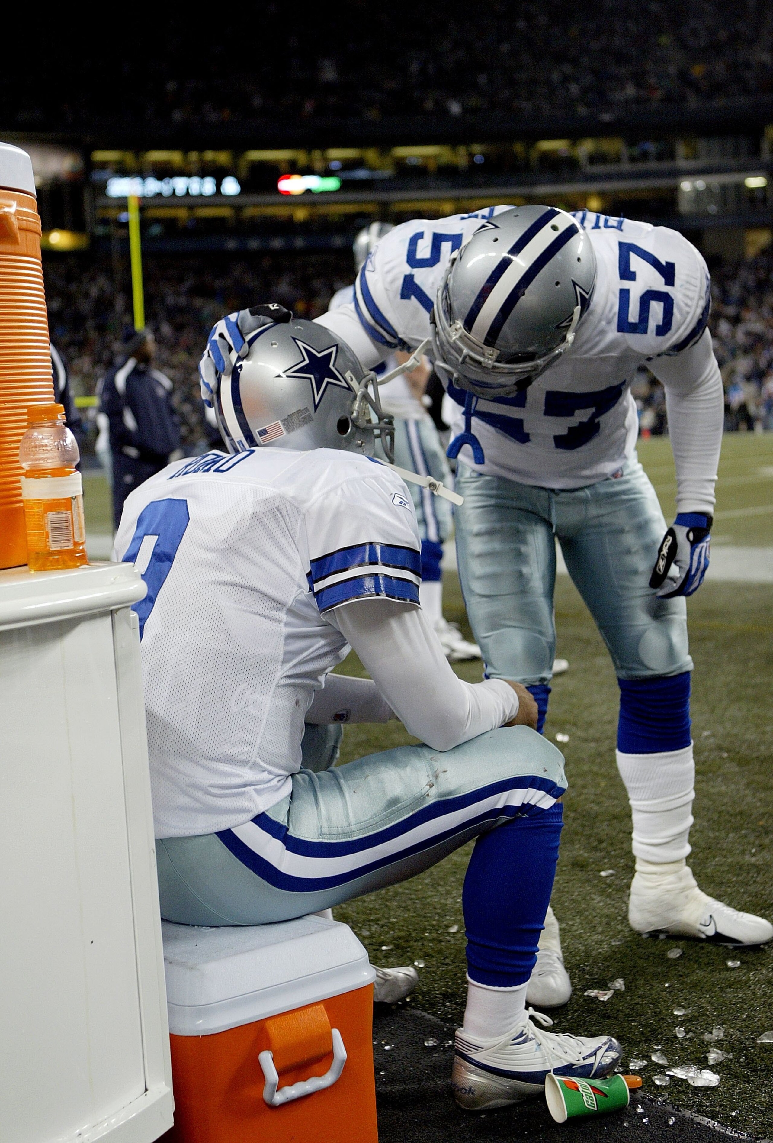 SEATTLE - JANUARY 06:  Quarterback Tony Romo #9 of the Dallas Cowboys is consoled by Kevin Burnett #57 after their team's loss to the Seattle Seahawks in the NFC Wild Card Playoff Game on January 6, 2007 at Qwest Field in Seattle, Washington.  (Photo by O