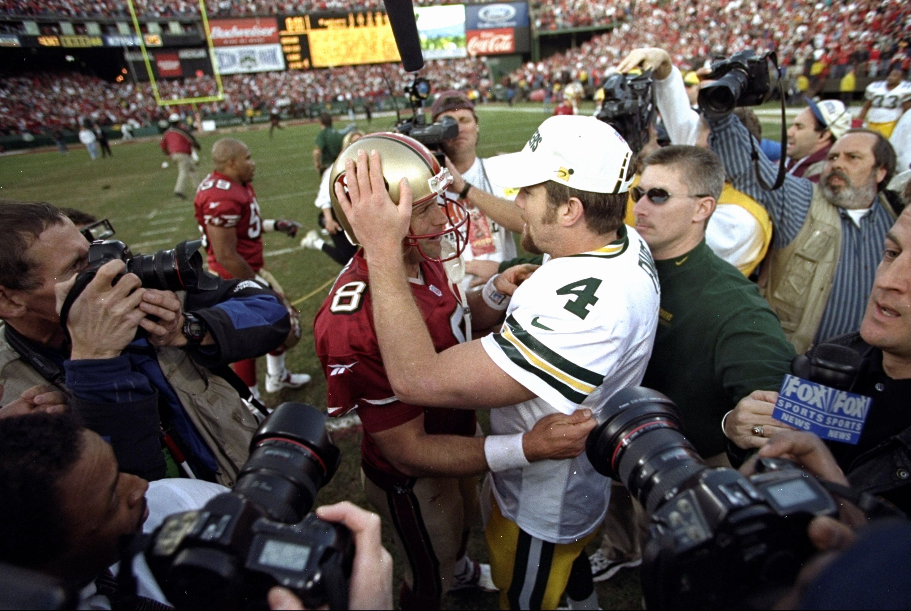 3 Jan 1999:  Quarterback Steve Young #8 of the San Francisco 49ers talks to quarterback Brett Favre #4 of the Green Bay Packers after the NFC Wild Card Game against the Green Bay Packe at 3Com Park in San Francisco, California. The 49ers defeated the Pack