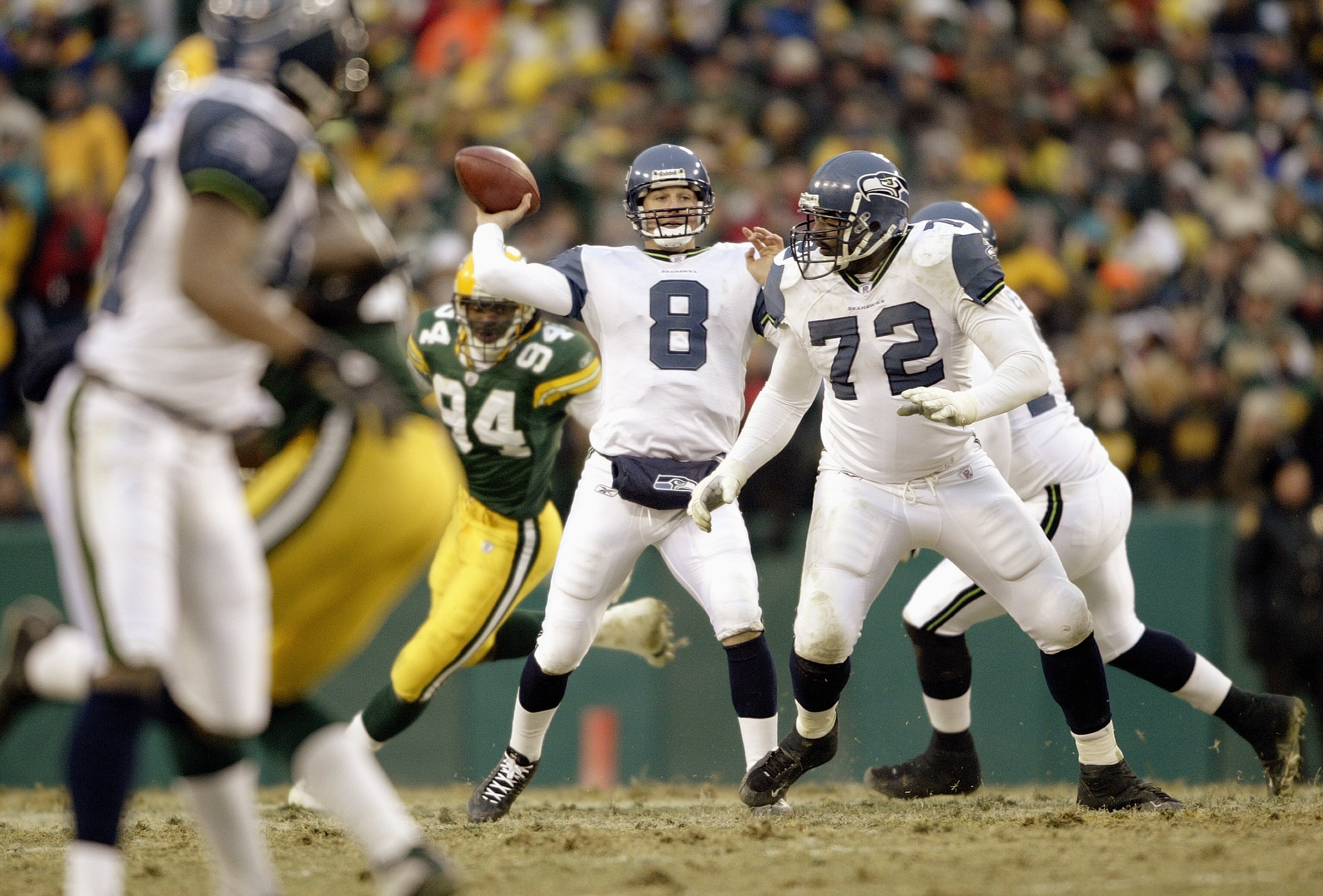 GREEN BAY, WI - JANUARY 4:  Quarterback Matt Hasselbeck #8 of the Seattle Seahawks throws the ball downfield during the NFC playoff game against the Green Bay Packers on January 4, 2004 in Lambeau Field in Green Bay, Wisconsin. The Packers defeated the Se