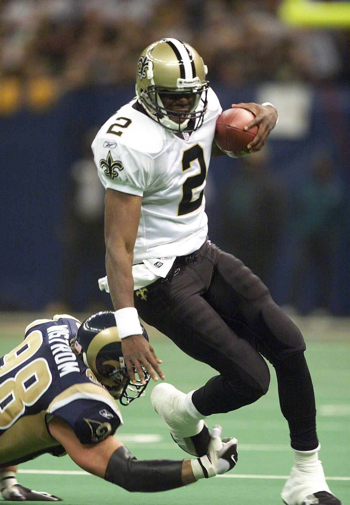 17 Dec 01:  Aaron Brooks #2 of the New Orleans Saints gets sacked by Grant Wistrom #98 of the St. Louis Rams during the first half of the St. Louis Rams at New Orleans Saints game at the Louisiana Superdome in New Orleans, Louisiana.  Digital Image Mandat