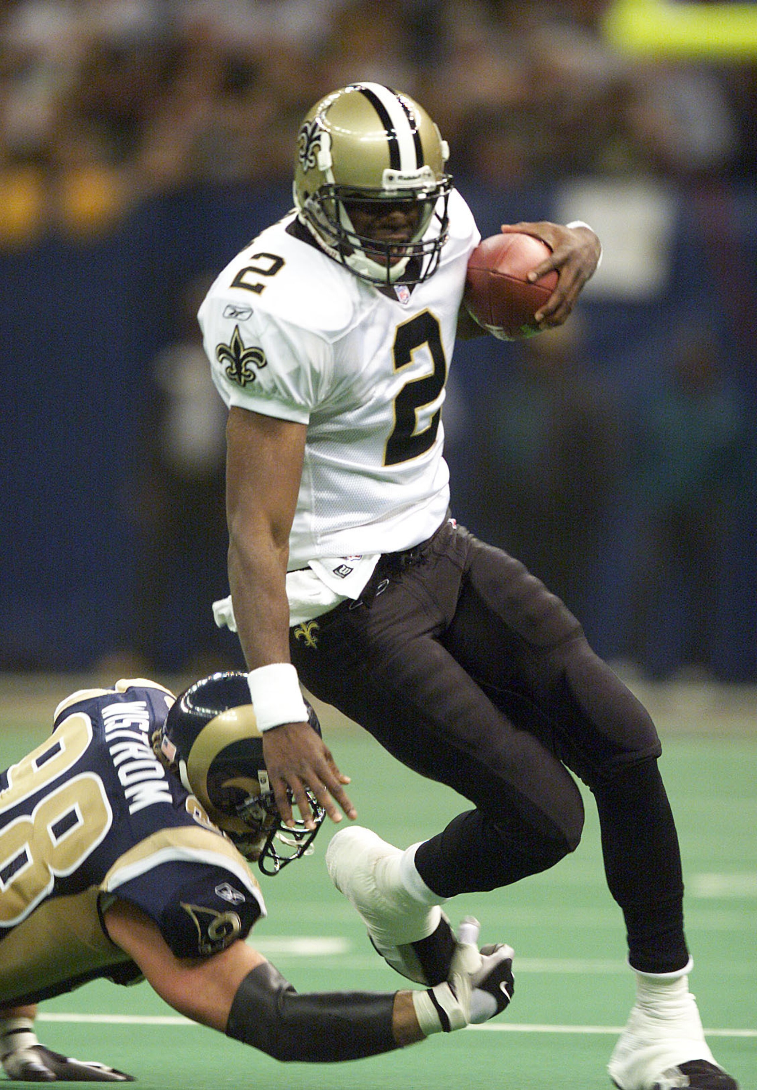 17 Dec 01:  Aaron Brooks #2 of the New Orleans Saints gets sacked by Grant Wistrom #98 of the St. Louis Rams during the first half of the St. Louis Rams at New Orleans Saints game at the Louisiana Superdome in New Orleans, Louisiana.  Digital Image Mandat