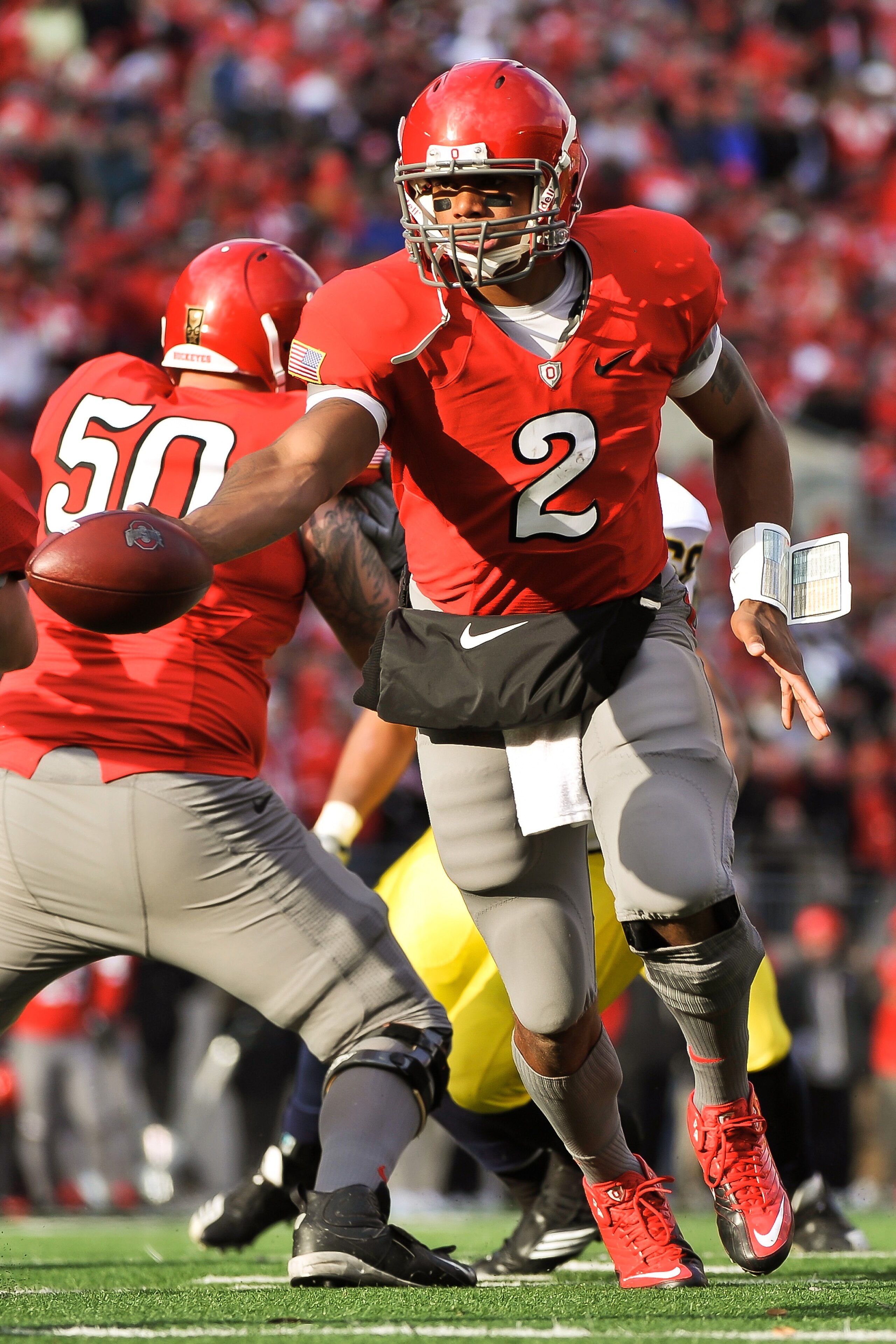 COLUMBUS, OH - NOVEMBER 27:  Quarterback Terrelle Pryor #2 of the Ohio State Buckeyes hands off against the Michigan Wolverines at Ohio Stadium on November 27, 2010 in Columbus, Ohio.  (Photo by Jamie Sabau/Getty Images)