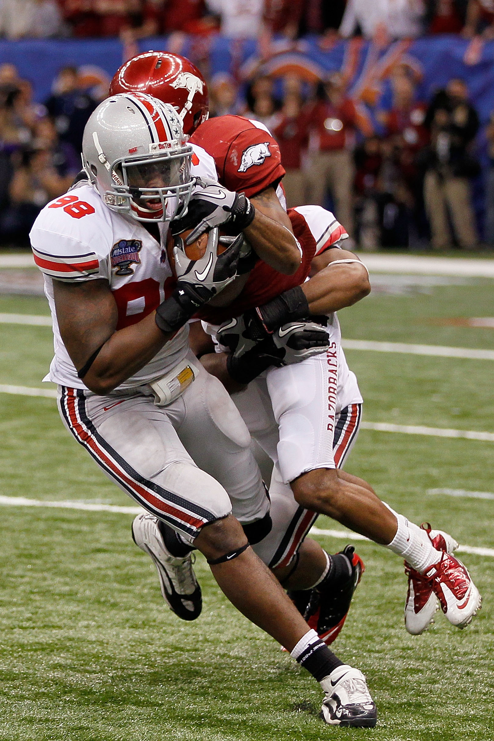 NEW ORLEANS, LA - JANUARY 04:  Solomon Thomas #98 of the Ohio State Buckeyes intercepts a pass as he is tackled by Jarius Wright #4 of the Arkansas Razorbacks to seal the 31-26 victory for the Buckeyes against the Razorbacks in the Allstate Sugar Bowl at