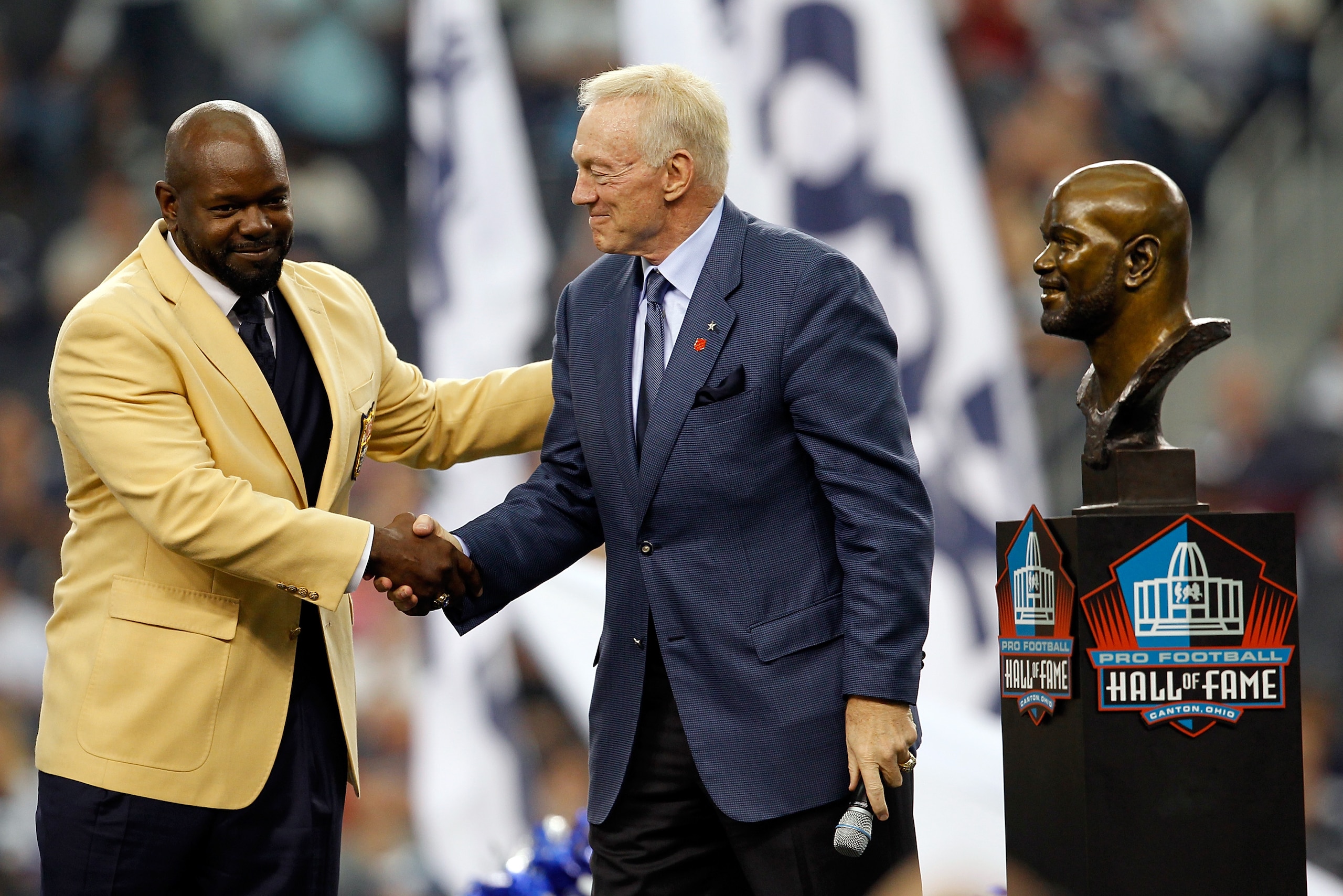 ARLINGTON, TX - NOVEMBER 21: Dallas Cowboys owner Jerry Jones (R) shakes hands with former Coaboys running back Emmitt Smith as Smith receives his Hall of Fame ring during a halftime ceremony at Cowboys Stadium on November 21, 2010 in Arlington, Texas. ARLINGTON, TX - NOVEMBER 21: Dallas Cowboys owner Jerry Jones (R) shakes hands with former Coaboys running back Emmitt Smith as Smith receives his Hall of Fame ring during a halftime ceremony at Cowboys Stadium on November 21, 2010 in Arlington, Texas.