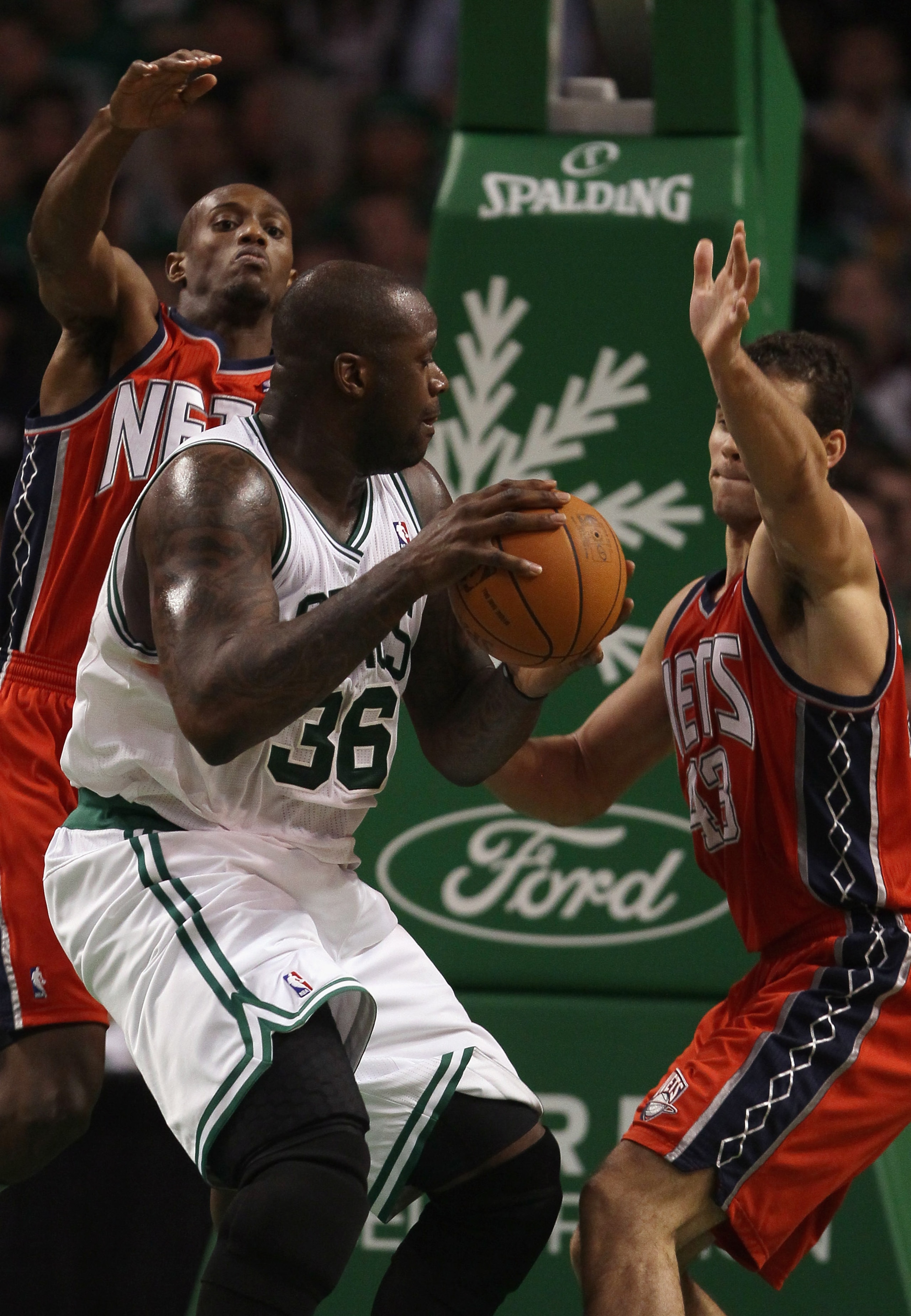 BOSTON - NOVEMBER 24: Shauquille O'Neal #36 of the Boston Celtics heads to the net as Kris Humphries #43 and Damion James #10 of the New Jersey Nets defend on November 24, 2010 at the TD Garden in Boston, Massachusetts. The Celtics defeated the nets 89-8 BOSTON - NOVEMBER 24: Shauquille O'Neal #36 of the Boston Celtics heads to the net as Kris Humphries #43 and Damion James #10 of the New Jersey Nets defend on November 24, 2010 at the TD Garden in Boston, Massachusetts. The Celtics defeated the nets 89-8