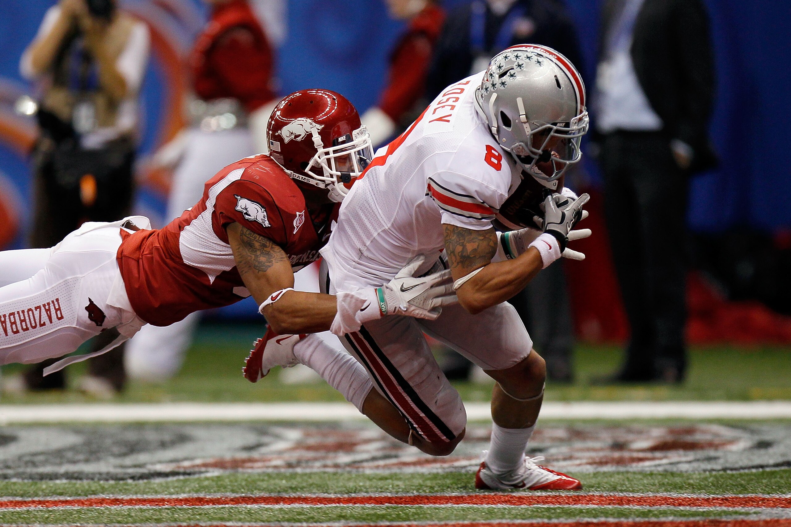 NEW ORLEANS, LA - JANUARY 04:  DeVier Posey #8 of the Ohio State Buckeyes catches a 43-yard touchdown catch against Tramain Thomas #5 of the Arkansas Razorbacks in the second quarter during the Allstate Sugar Bowl at the Louisiana Superdome on January 4,