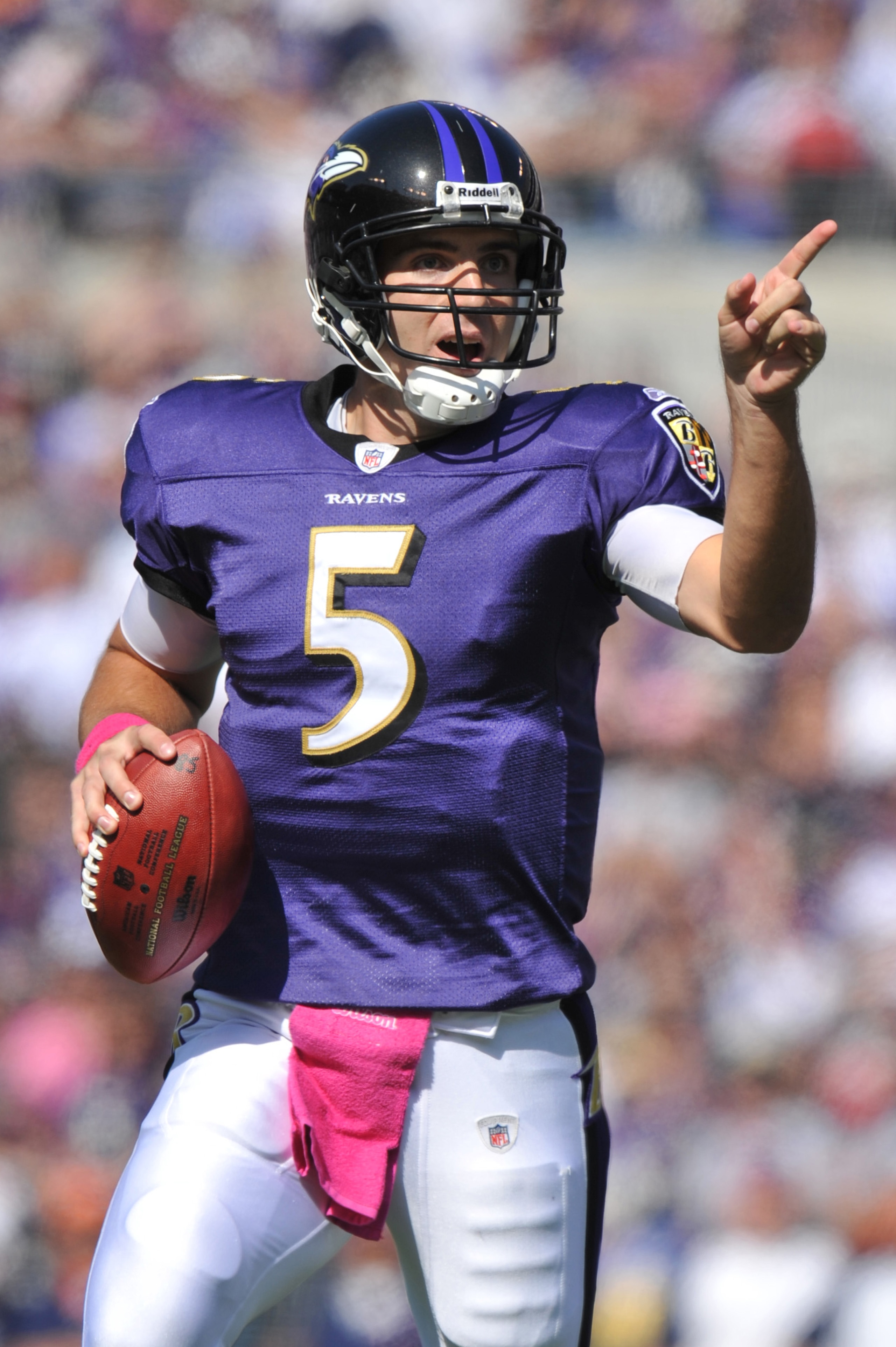 BALTIMORE, MD - OCTOBER 10: Joe Flacco #5 of the Baltimore Ravens looks for a receiver during the game against the Denver Broncos at M&T Bank Stadium on October 10, 2010 in Baltimore, Maryland. Players wore pink in recognition of Breast Cancer Awareness M