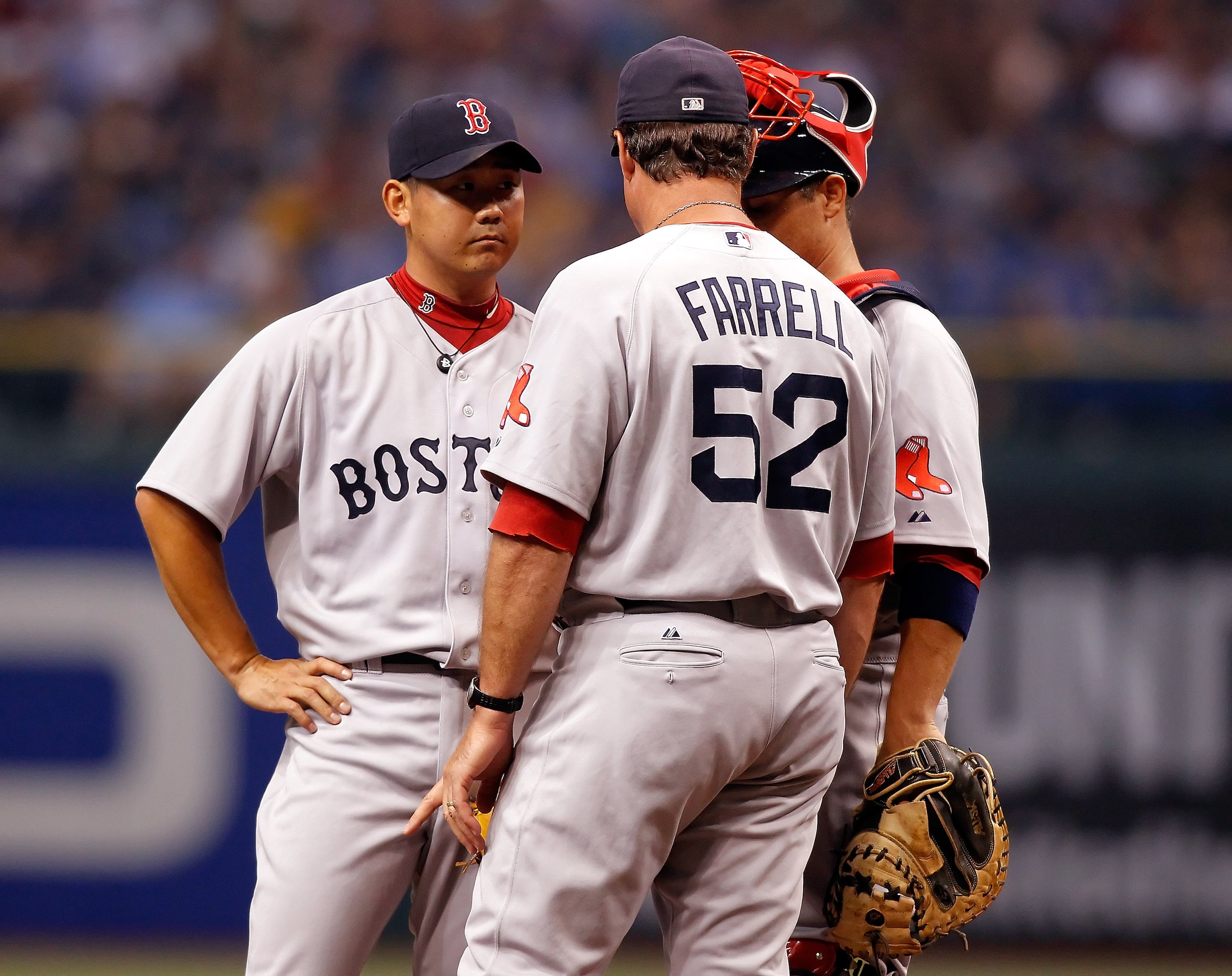 ST. PETERSBURG, FL - JULY 05:  Pitching coach John Farrell #52 of the Boston Red Sox has a chat with pitcher Daisuke Matsuzaka #18 and catcher Kevin Cash #36 against the Tampa Bay Rays during the game at Tropicana Field on July 5, 2010 in St. Petersburg, 