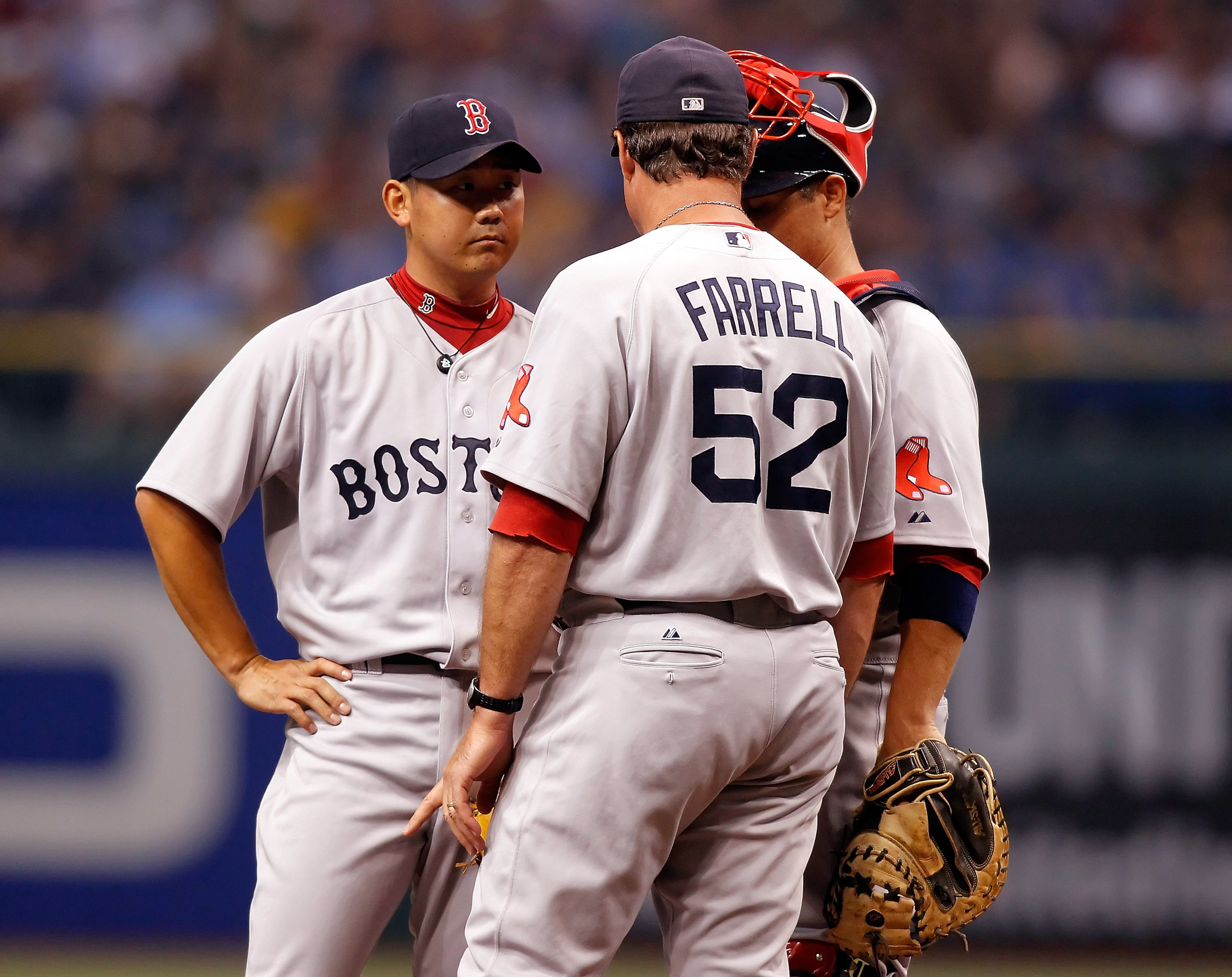 ST. PETERSBURG, FL - JULY 05:  Pitching coach John Farrell #52 of the Boston Red Sox has a chat with pitcher Daisuke Matsuzaka #18 and catcher Kevin Cash #36 against the Tampa Bay Rays during the game at Tropicana Field on July 5, 2010 in St. Petersburg, 