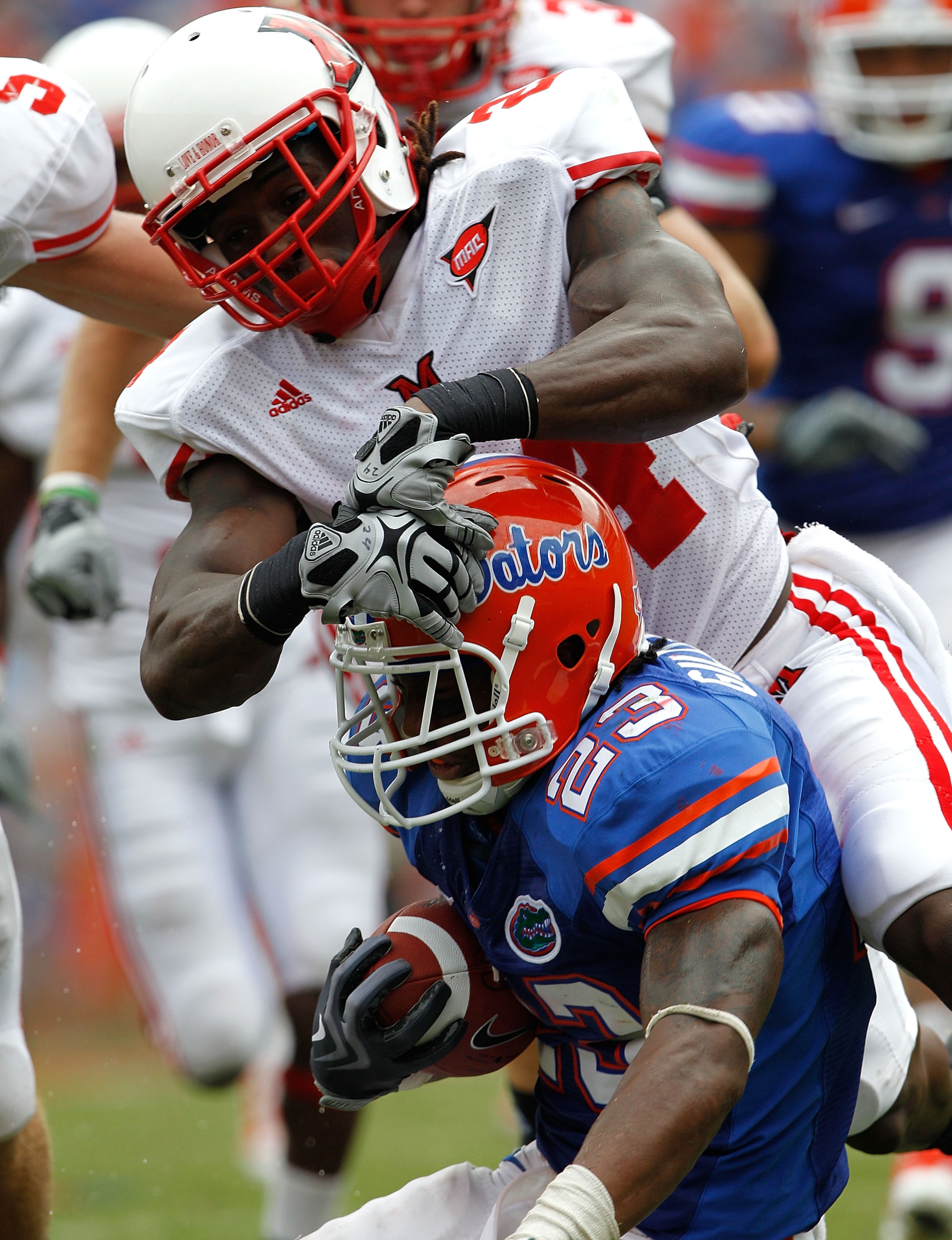 GAINESVILLE, FL - SEPTEMBER 04:  Mike Gillislee #23 of the Florida Gators is tackled by Allen Veazie #2 of the Miami University RedHawks at Ben Hill Griffin Stadium on September 4, 2010 in Gainesville, Florida.  (Photo by Sam Greenwood/Getty Images)