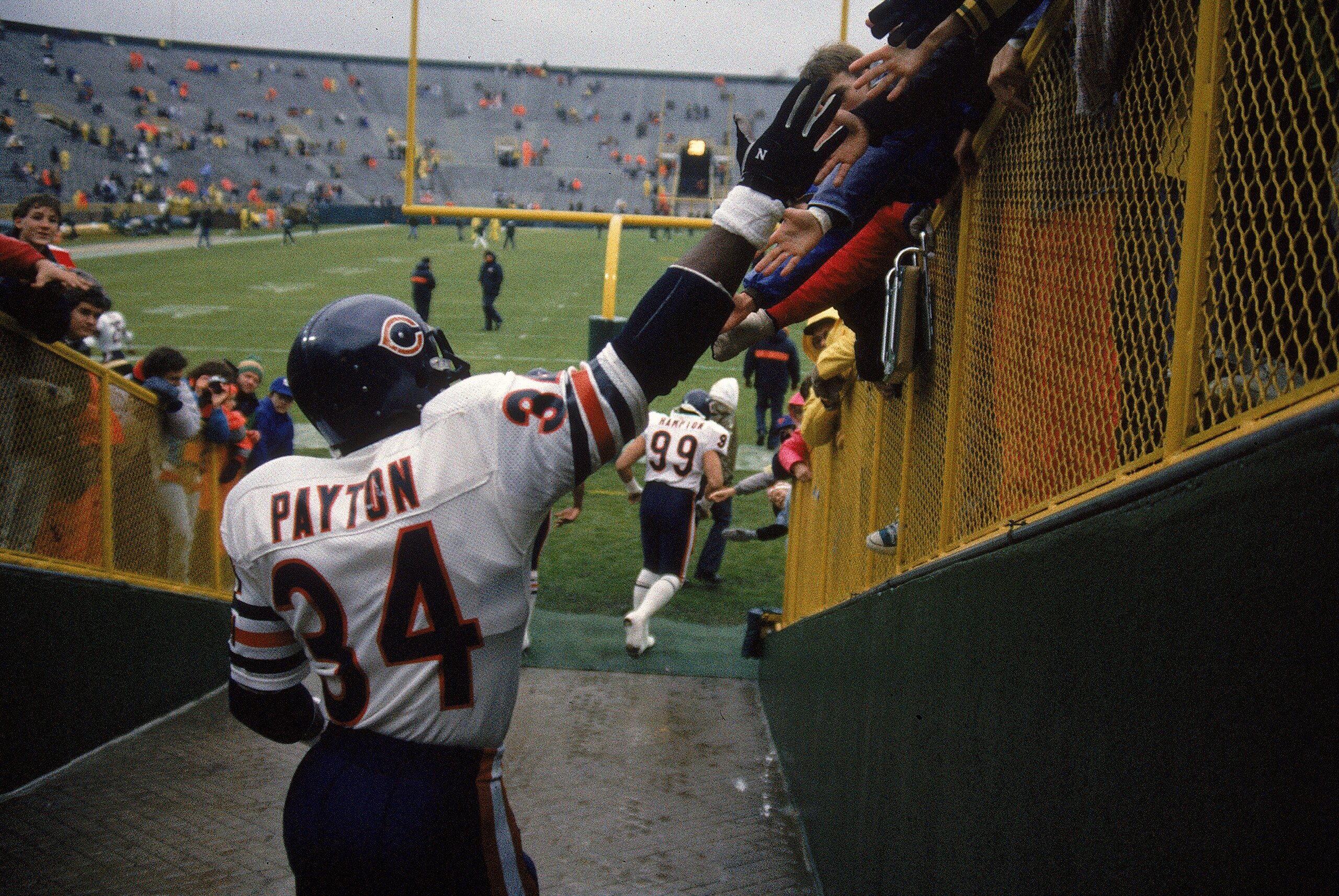 21 May 1999: Walter Payton #34 of the Chicago Bears shakes hands with fans before a game against the Green Bay Packers in Green Bay, Wisconsin. 21 May 1999: Walter Payton #34 of the Chicago Bears shakes hands with fans before a game against the Green Bay Packers in Green Bay, Wisconsin.
