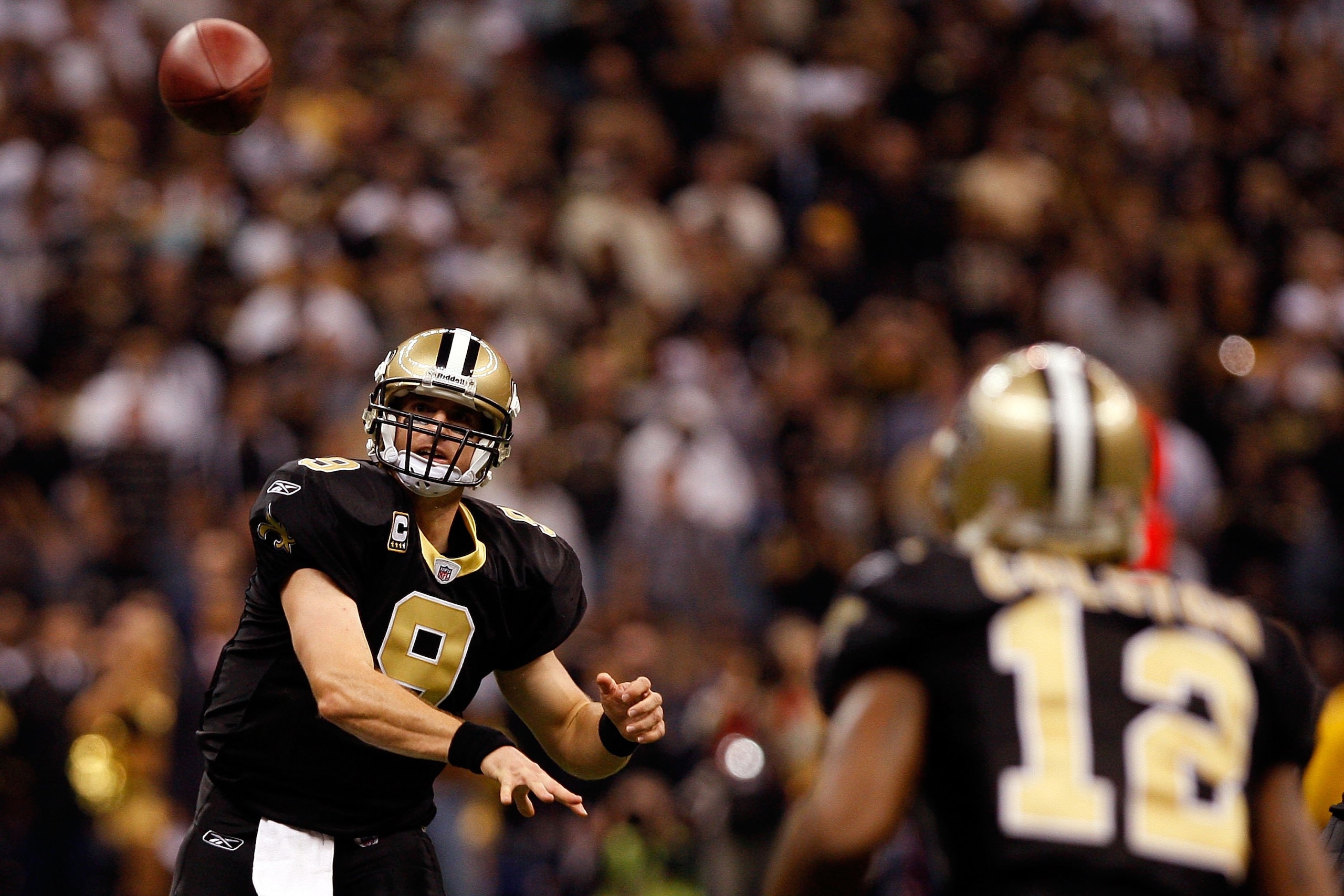 NEW ORLEANS - NOVEMBER 02:  Quarterback Drew Brees #9 of the New Orleans Saints throws a pass to Marques Colston #12 of the New Orleans Saints during the game against the Atlanta Falcons at Louisana Superdome on November 2, 2009 in New Orleans, Louisiana.