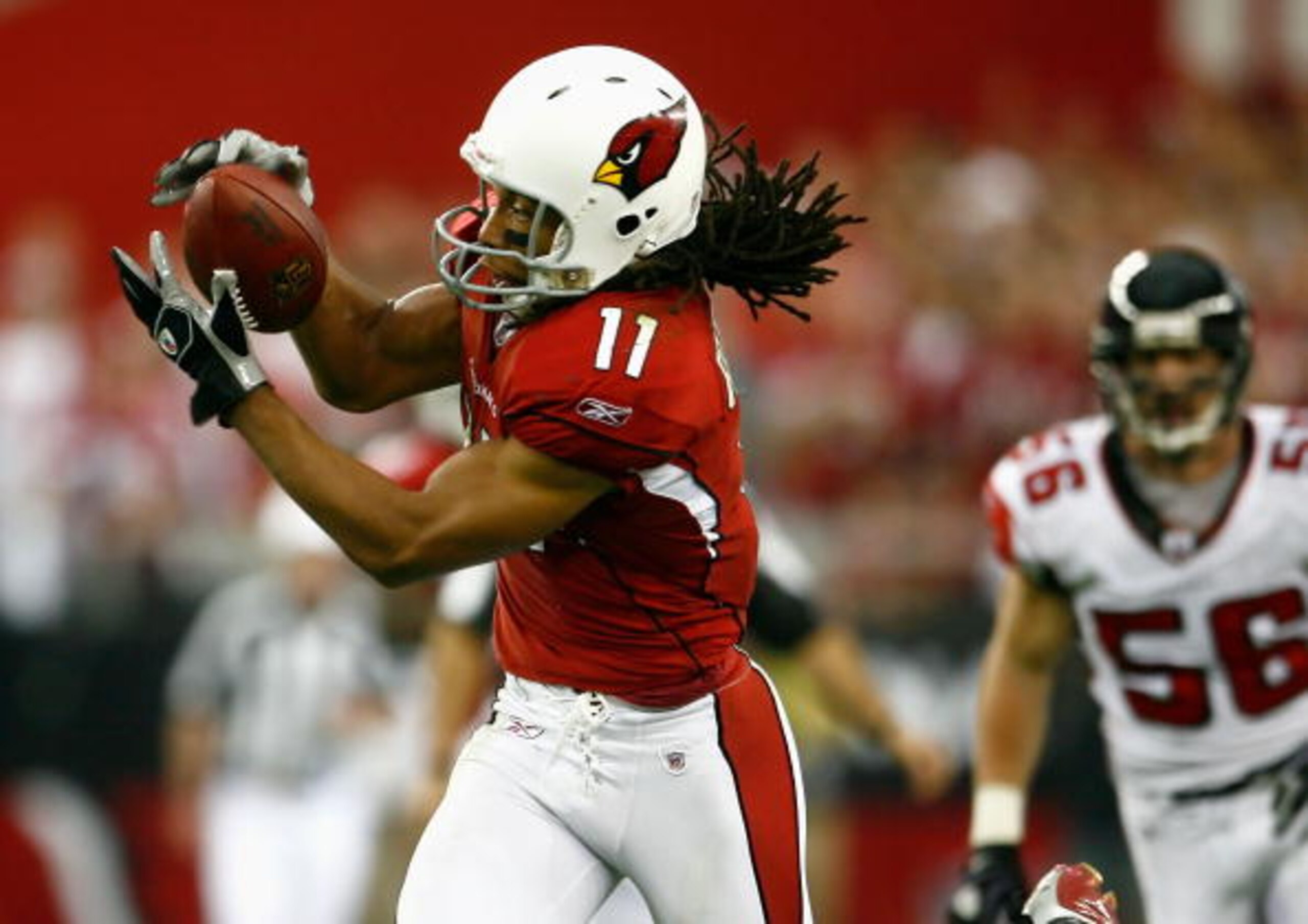 GLENDALE, AZ - JANUARY 03:  Wide receiver Larry Fitzgerald #11 of the Arizona Cardinals makes a reception against the Atlanta Falcons during the NFC Wild Card Game on January 3, 2009 at University of Phoenix Stadium in Glendale, Arizona. The Cardinals def