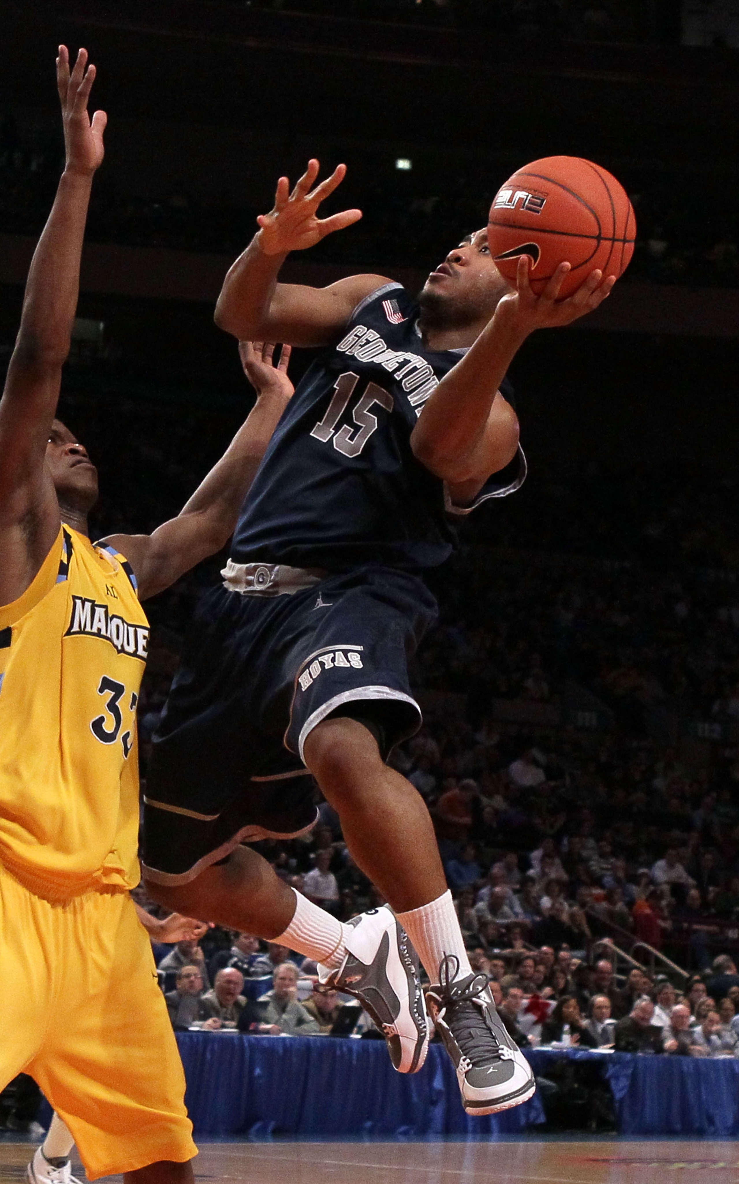 NEW YORK - MARCH 12: Austin Freeman #15 of the Georgetown Hoyas goes up with the ball against Jimmy Butler #33 the Marquette Golden Eagles during the semifinal of the 2010 Big East Tournament at Madison Square Garden on March 12, 2010 in New York City.  (