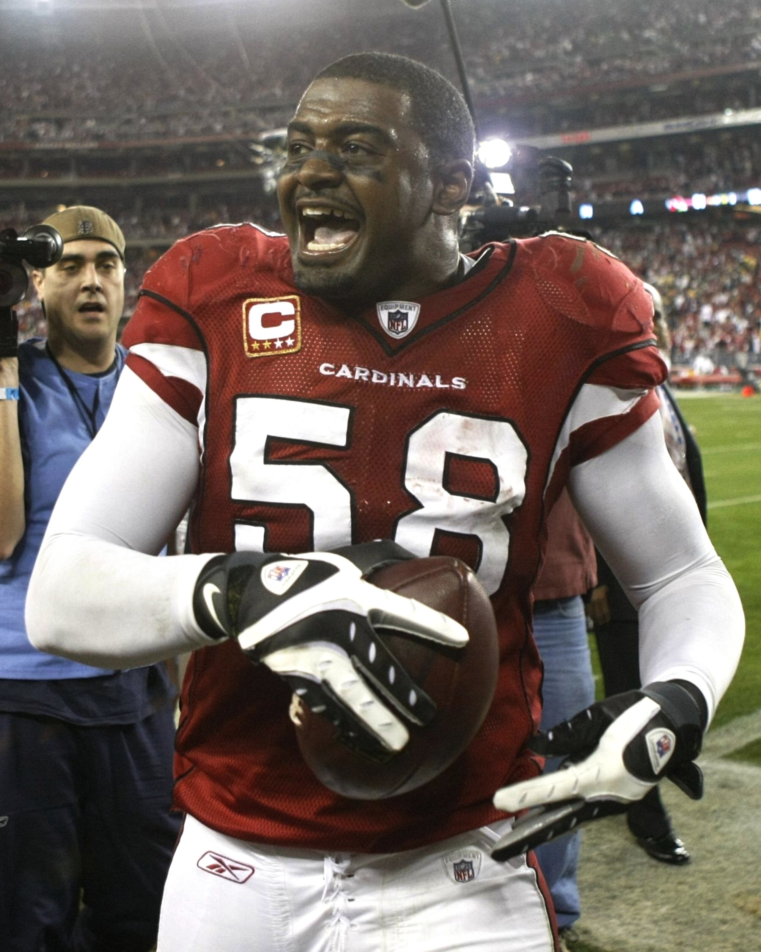 GLENDALE, AZ - JANUARY 10:  Linebacker Karlos Dansby #58 of the Arizona Cardinals walks off the field after defeating the Green Bay Packers 51-45 in the 2010 NFC wild-card playoff game at University of Phoenix Stadium on January 10, 2010 in Glendale, Ariz