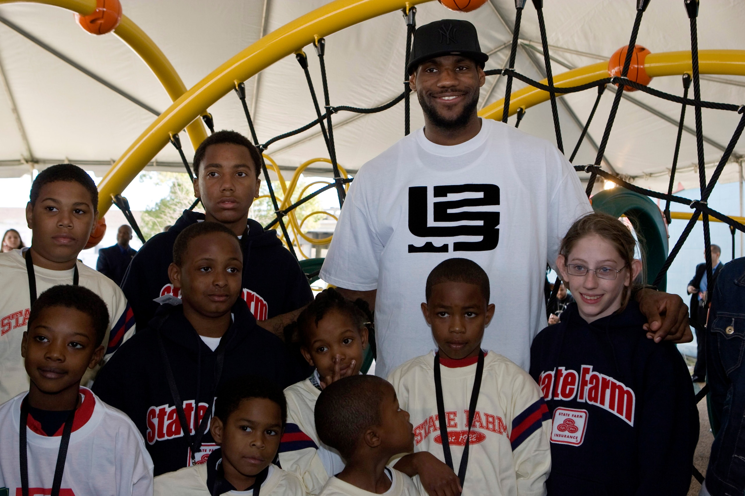 NEW ORLEANS - FEBRUARY 14:  LeBron James of the Cleveland Cavaliers poses with neighborhood children at a playground dedication by State Farm Insurance and the LeBron James Family Foundation at the St. Bernard Recreation Center February 14, 2008 in New Or