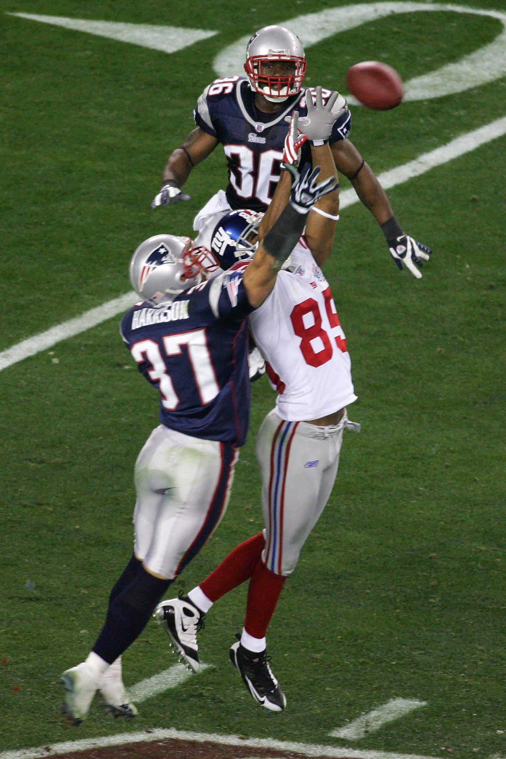 GLENDALE, AZ - FEBRUARY 03:  David Tyree #85 of the New York Giants catches a 32-yard pass from Eli Manning #10 as Rodney Harrison #37 of the New England Patriots attempts to knock it out in the fourth quarter of Super Bowl XLII on February 3, 2008 at the