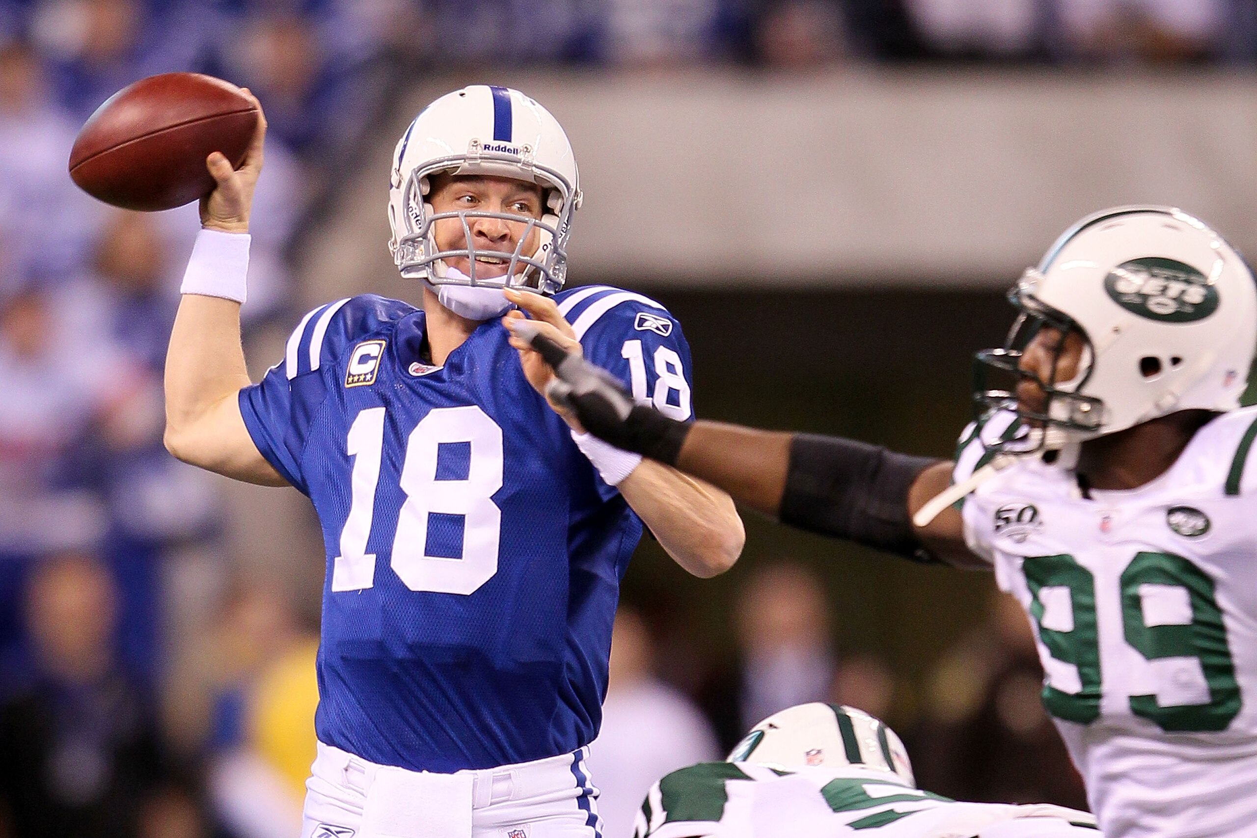 INDIANAPOLIS - JANUARY 24:  Quarterback Peyton Manning #18 of the Indianapolis Colts throws the ball as he is pressured by  Bryan Thomas #99 of the New York Jets in the first quarter during the AFC Championship Game at Lucas Oil Stadium on January 24, 201