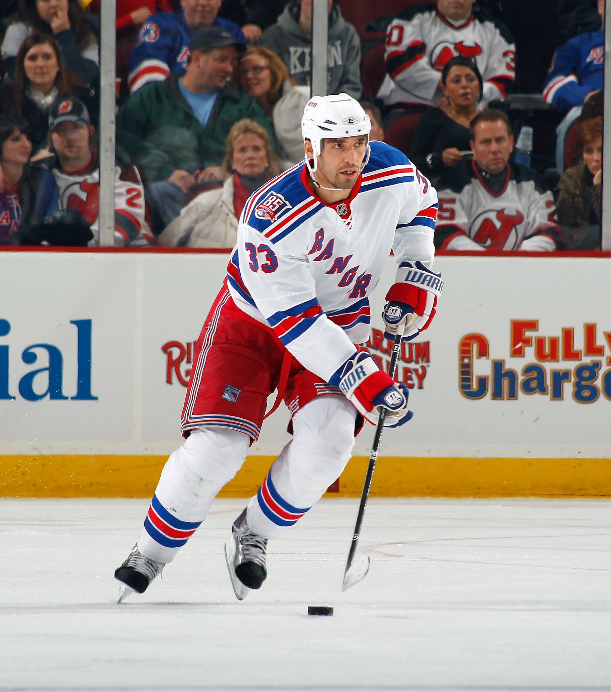 NEWARK, NJ - DECEMBER 29:  Michal Rozsival #33 of the New York Rangers skates with the puckagainst the New Jersey Devils during a game on December 29, 2010 at the Prudential Center in Newark, New Jersey. The Rangers won 3-1.  (Photo by Lou Capozzola/Getty
