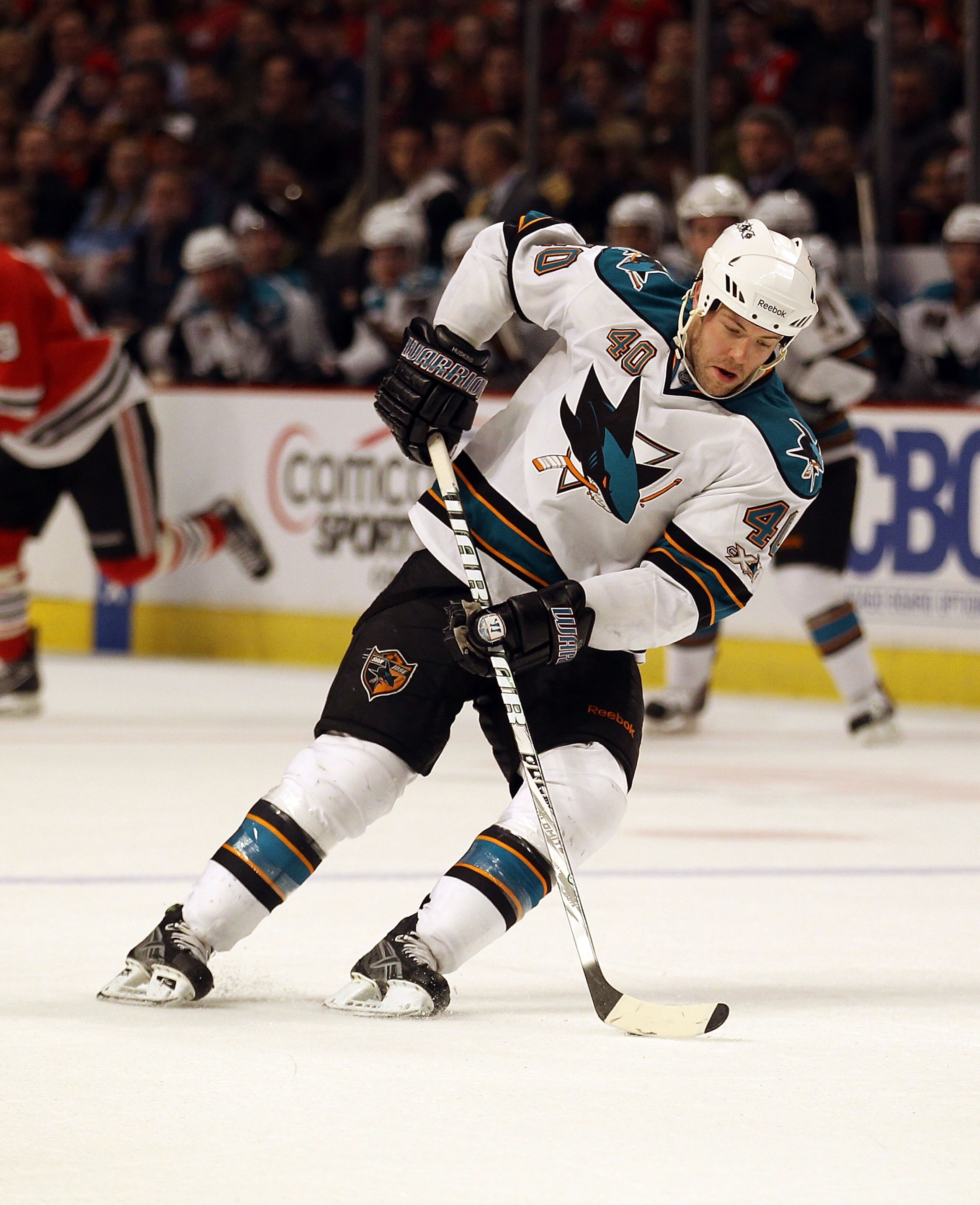 CHICAGO, IL - DECEMBER 30: Kent Huskins #40 of the San Jose Sharks controls the puck against the Chicago Blackhawks at the United Center on December 30, 2010 in Chicago, Illinois. The Sharks defeated the Blackhawks 5-3. (Photo by Jonathan Daniel/Getty Ima