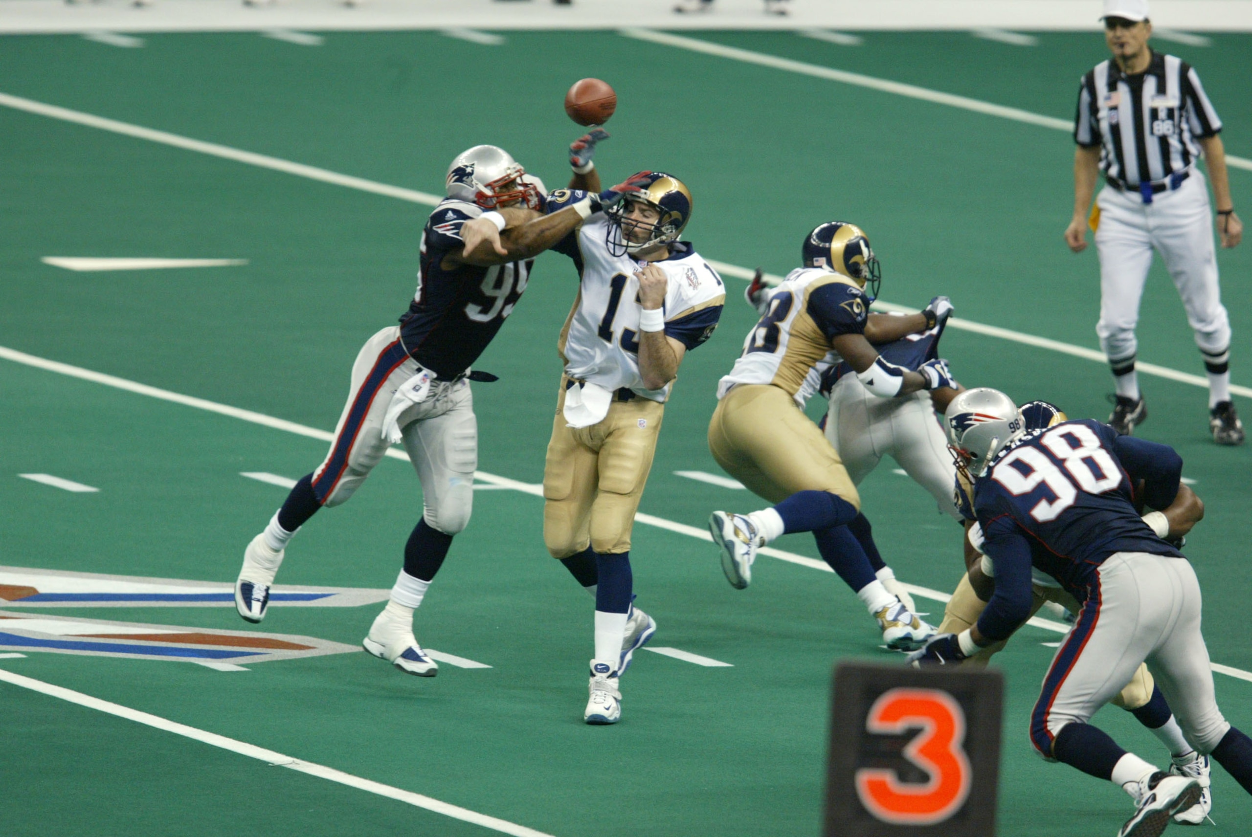 03 Feb 2002:   Roman Phifer #95 of the New England Patriots breaks a pass by quarterback Kurt Warner #13 of the St.Louis Rams during Superbowl XXXVI at the Superdome in New Orleans, Louisiana.  The Patriots defeated the Rams 20-17. DIGITAL IMAGE. Mandator