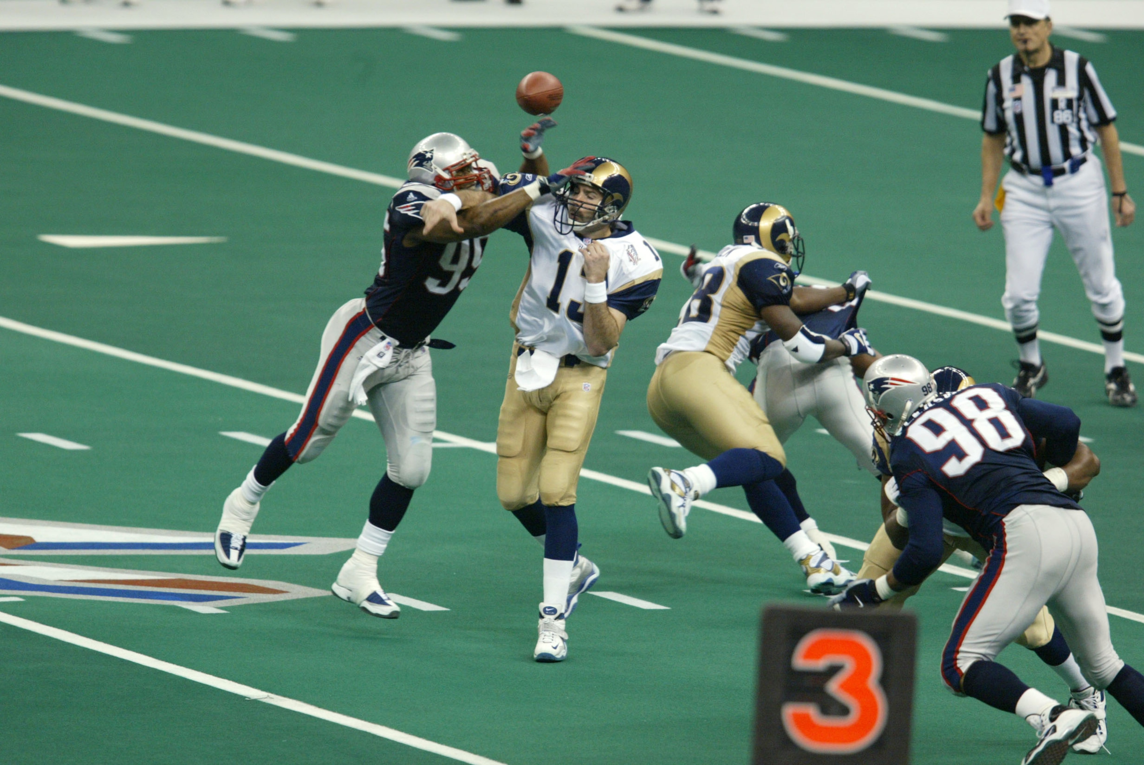 03 Feb 2002:   Roman Phifer #95 of the New England Patriots breaks a pass by quarterback Kurt Warner #13 of the St.Louis Rams during Superbowl XXXVI at the Superdome in New Orleans, Louisiana.  The Patriots defeated the Rams 20-17. DIGITAL IMAGE. Mandator