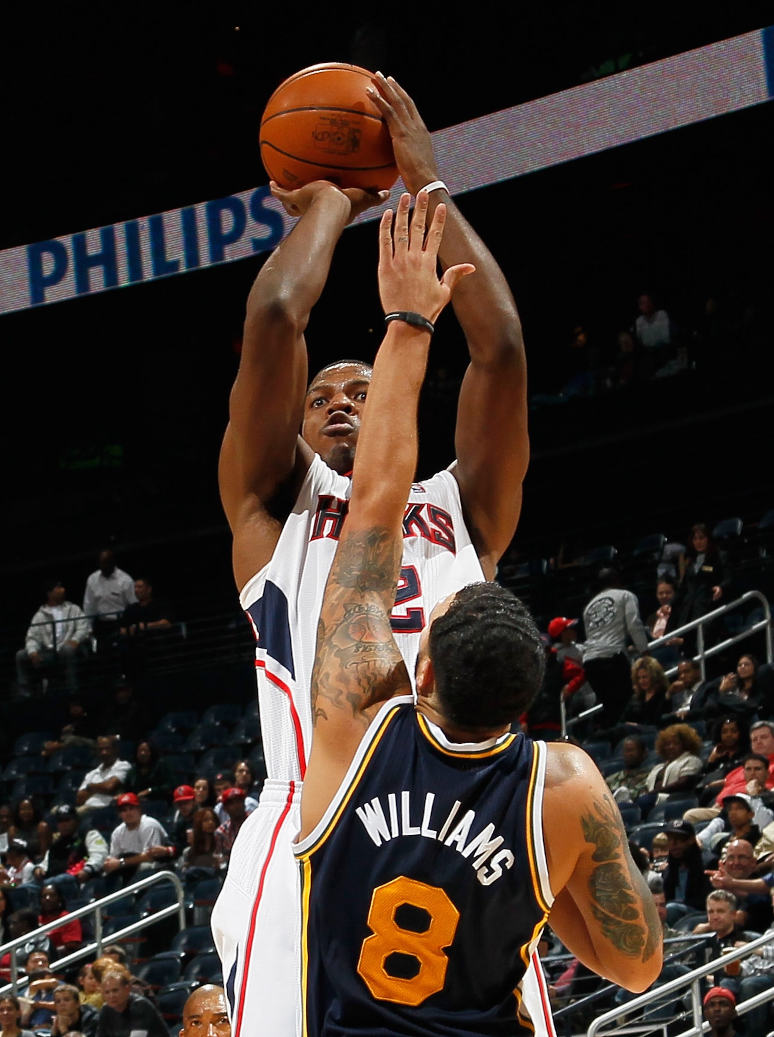 ATLANTA - NOVEMBER 12: Joe Johnson #2 of the Atlanta Hawks shoots over Deron Williams #8 of the Utah Jazz at Philips Arena on November 12, 2010 in Atlanta, Georgia. NOTE TO USER: User expressly acknowledges and agrees that, by downloading and/or using t ATLANTA - NOVEMBER 12: Joe Johnson #2 of the Atlanta Hawks shoots over Deron Williams #8 of the Utah Jazz at Philips Arena on November 12, 2010 in Atlanta, Georgia. NOTE TO USER: User expressly acknowledges and agrees that, by downloading and/or using t