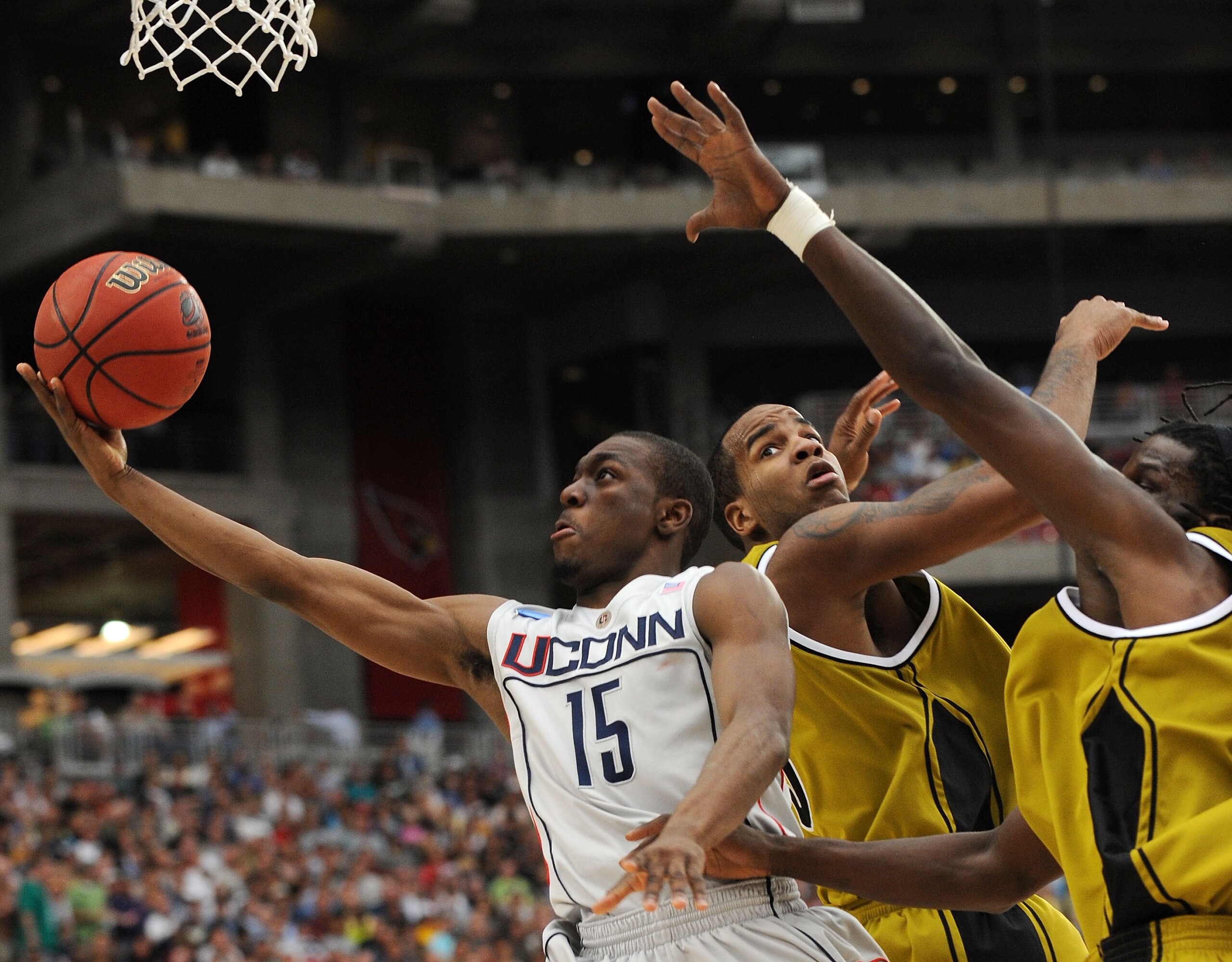 GLENDALE, AZ - MARCH 28:  (L-R) Guard Kemba Walker #15 of the Connecticut Huskies goes up for a shot against forwards Leo Lyons #5 and DeMarre Carroll #1 of the Missouri Tigers in the Elite Eight of the NCAA Division I Men's Basketball Tournament at the U