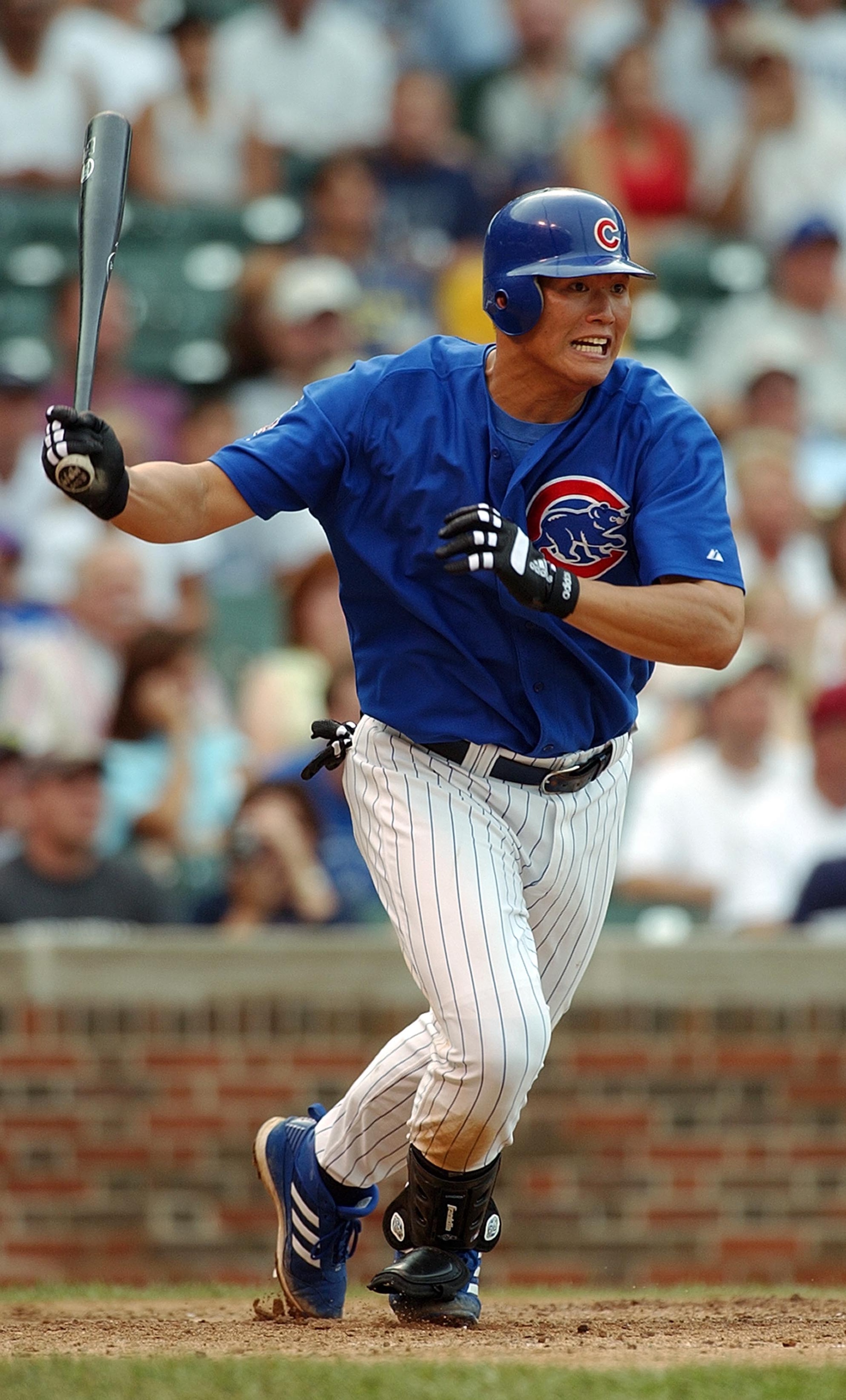 CHICAGO - AUGUST 3:  First baseman Hee Seop Choi #19 of the Chicago Cubs hits a single in the fourth inning against the Arizona Diamondbacks during the MLB game at Wrigley Field on August 3, 2003 in Chicago, Illinois. The Cubs defeated the Diamondbacks 2-