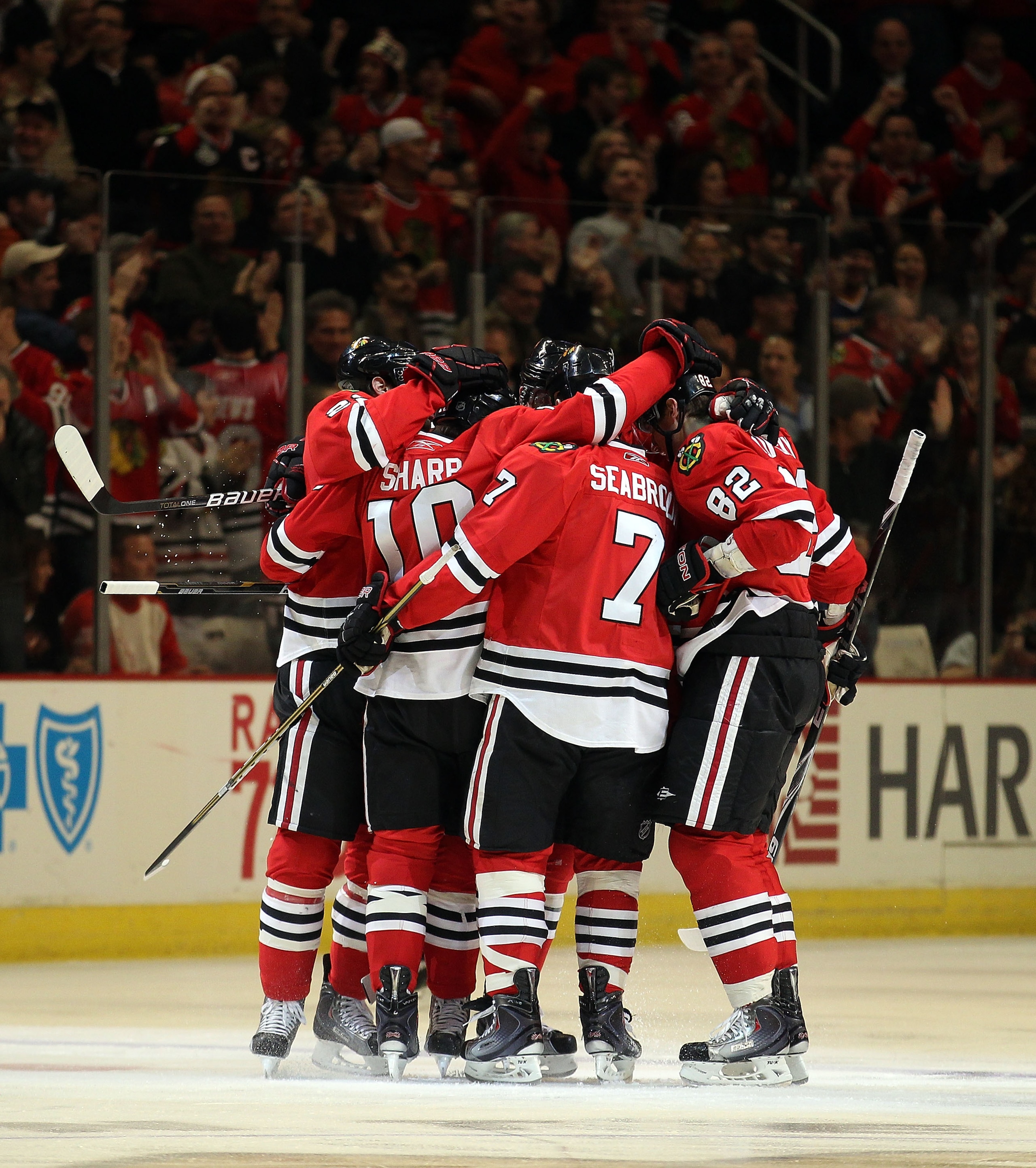 CHICAGO, IL - DECEMBER 17: Patrick Sharp #10 of the Chicago Blackhawks celebrates a 1st period goal  with teammates including Brent Seabrook #7 and Tomas Kopecky #82 against the Detroit Red Wings at the United Center on December 17, 2010 in Chicago, Illin