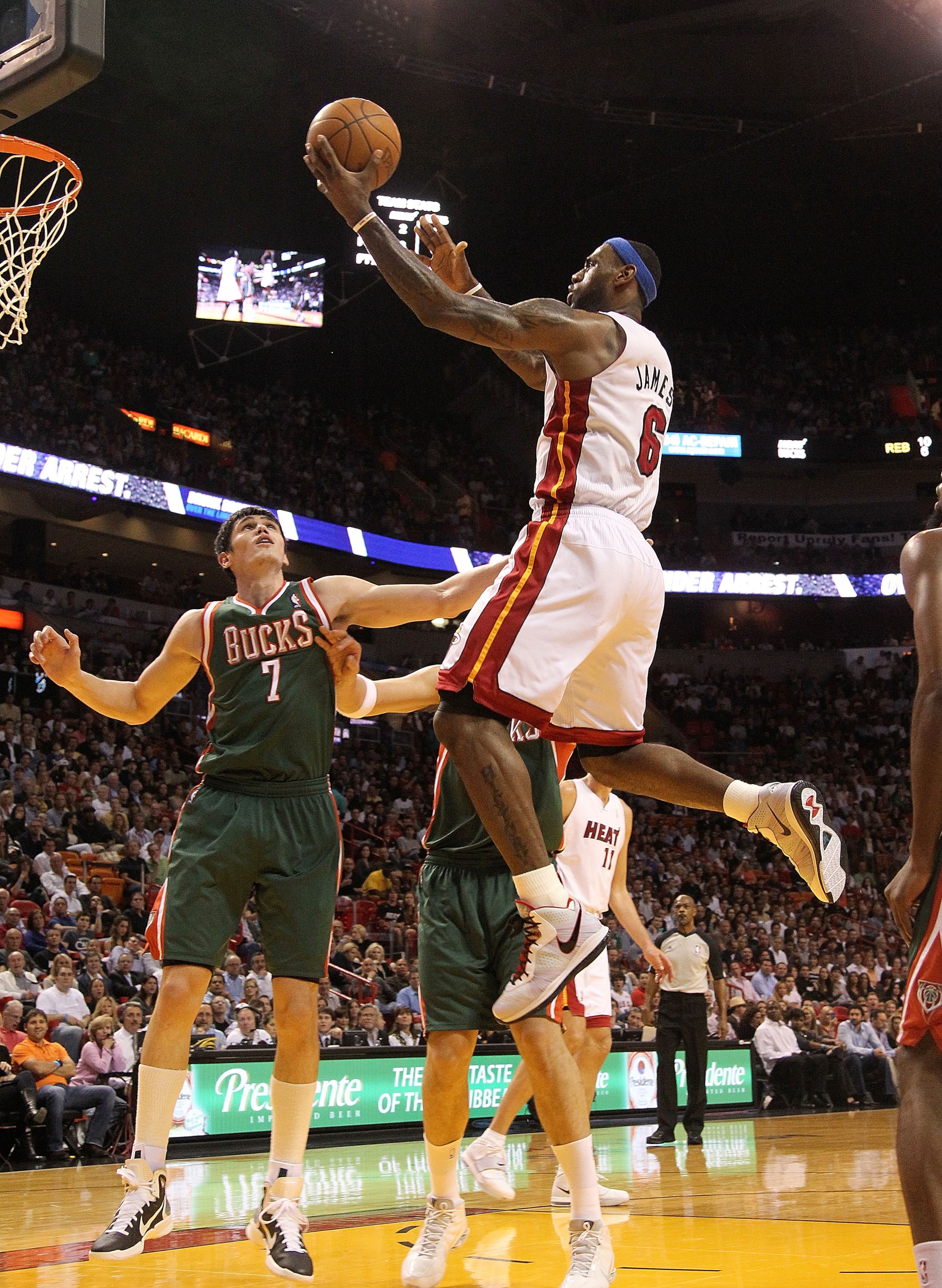 MIAMI, FL - JANUARY 04:  LeBron James #6 of the Miami Heat drives to the rim over Ersan Ilyasova #7 of the Milwaukee Bucks during a game  at American Airlines Arena on January 4, 2011 in Miami, Florida. NOTE TO USER: User expressly acknowledges and agrees