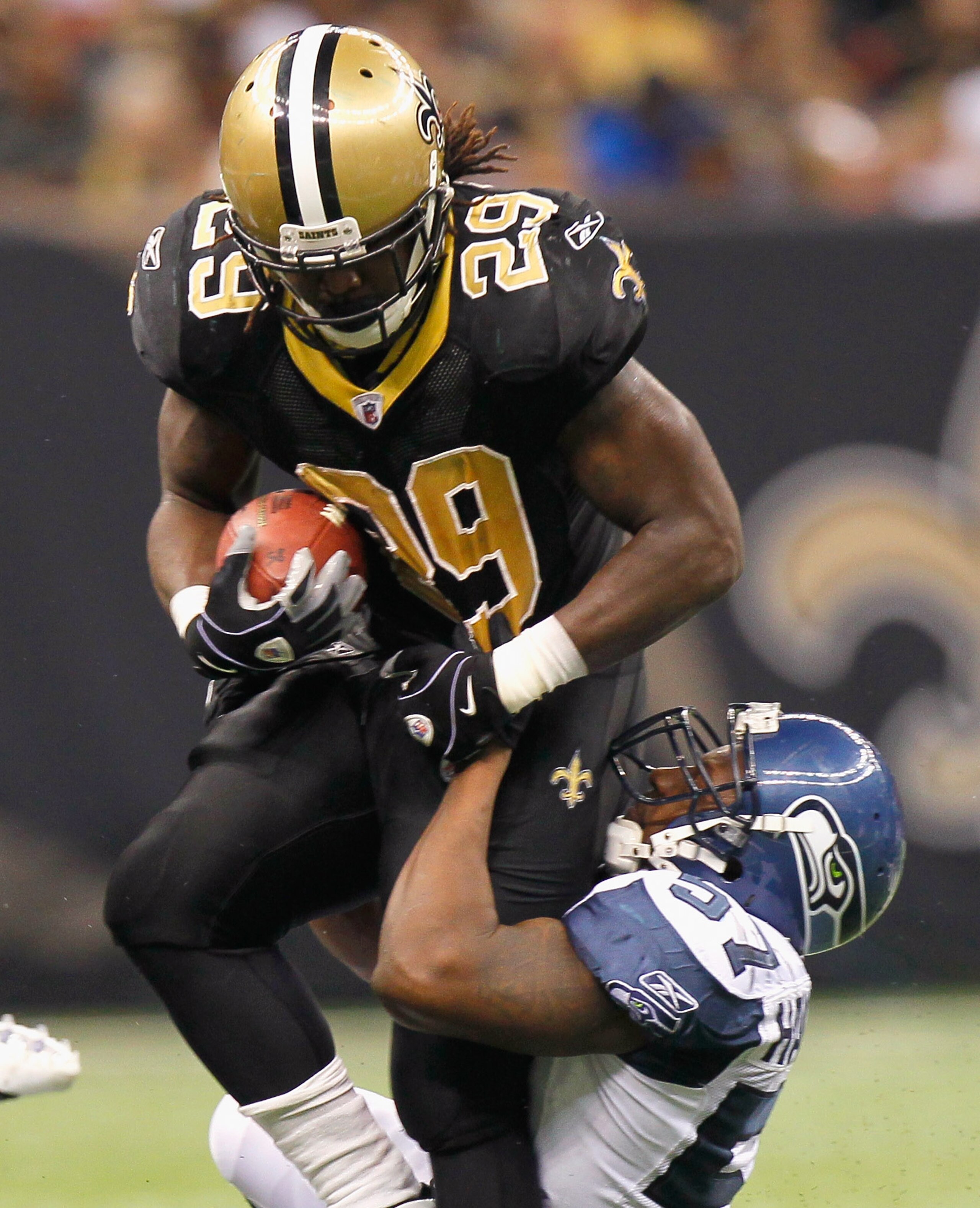 NEW ORLEANS - NOVEMBER 21:  Chris Ivory #29 of the New Orleans Saints is tackled by David Hawthorne #57 of the Seattle Seahawks at Louisiana Superdome on November 21, 2010 in New Orleans, Louisiana.  (Photo by Kevin C. Cox/Getty Images)