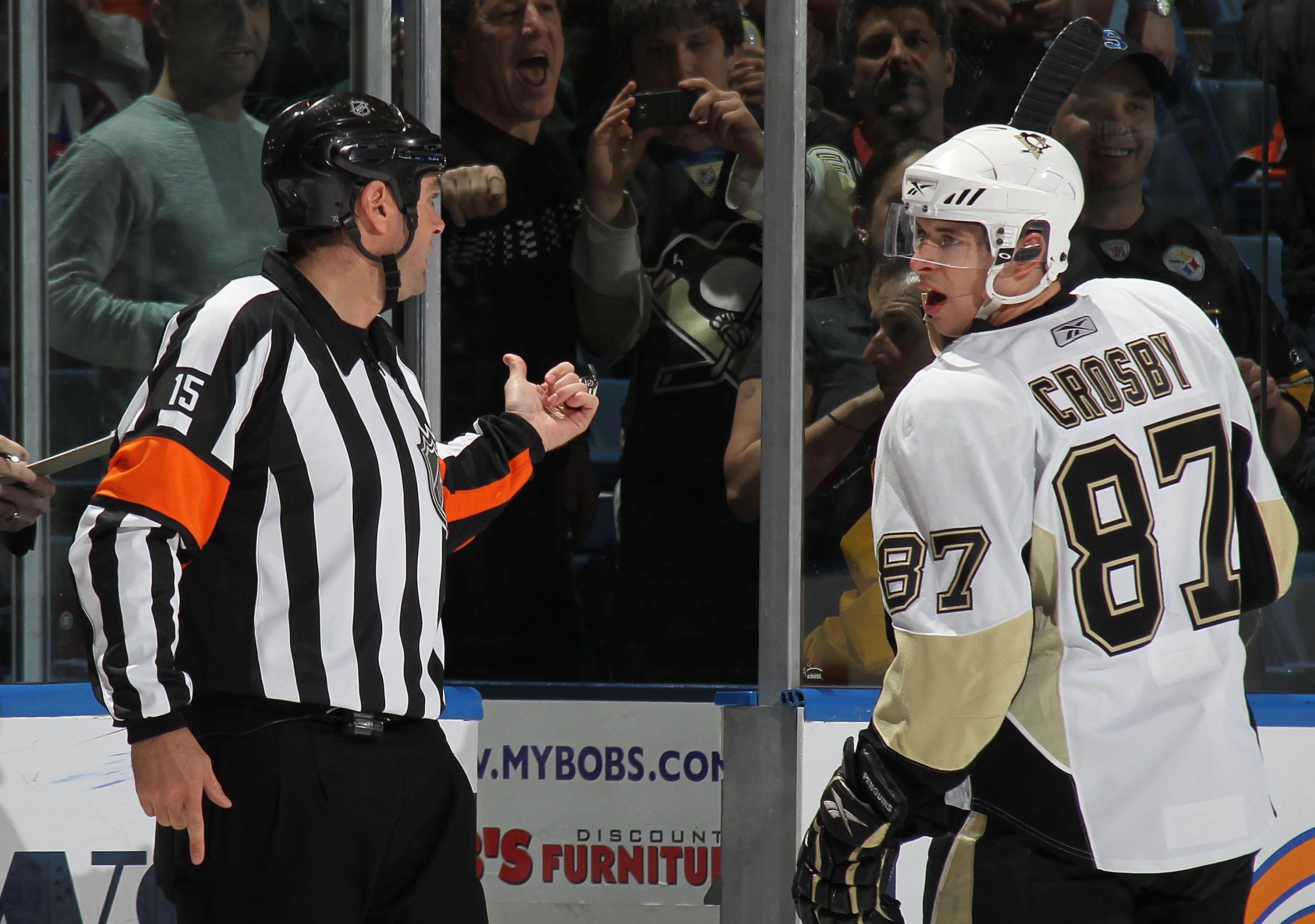 UNIONDALE, NY - APRIL 11: Sidney Crosby #87 of the Pittsburgh Penguins is sent to the penalty box by referee Stephane Auger #15 in his game against the New York Islanders at the Nassau Coliseum on April 11, 2010 in Uniondale, New York. (Photo by Bruce Ben