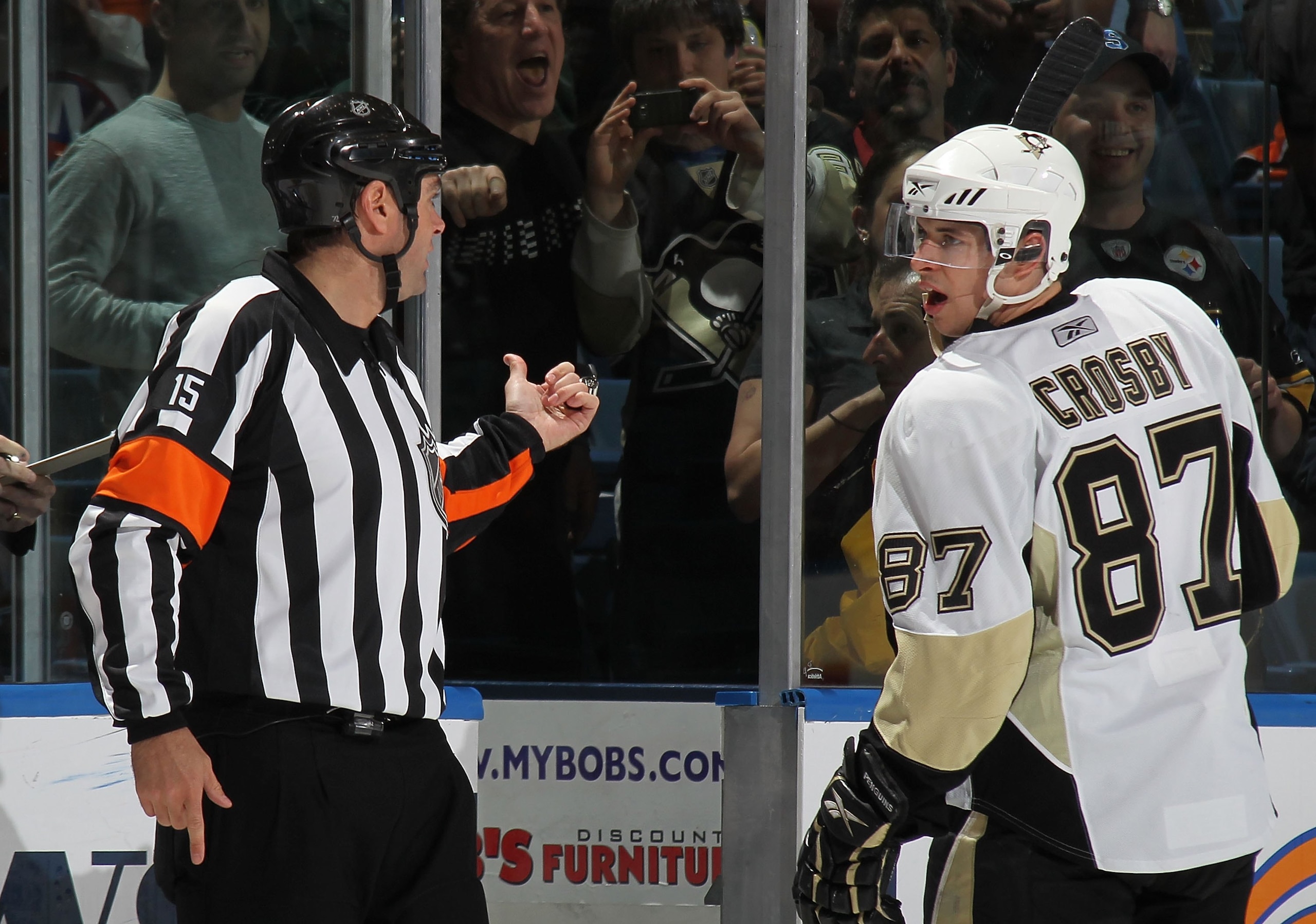 UNIONDALE, NY - APRIL 11: Sidney Crosby #87 of the Pittsburgh Penguins is sent to the penalty box by referee Stephane Auger #15 in his game against the New York Islanders at the Nassau Coliseum on April 11, 2010 in Uniondale, New York. (Photo by Bruce Ben