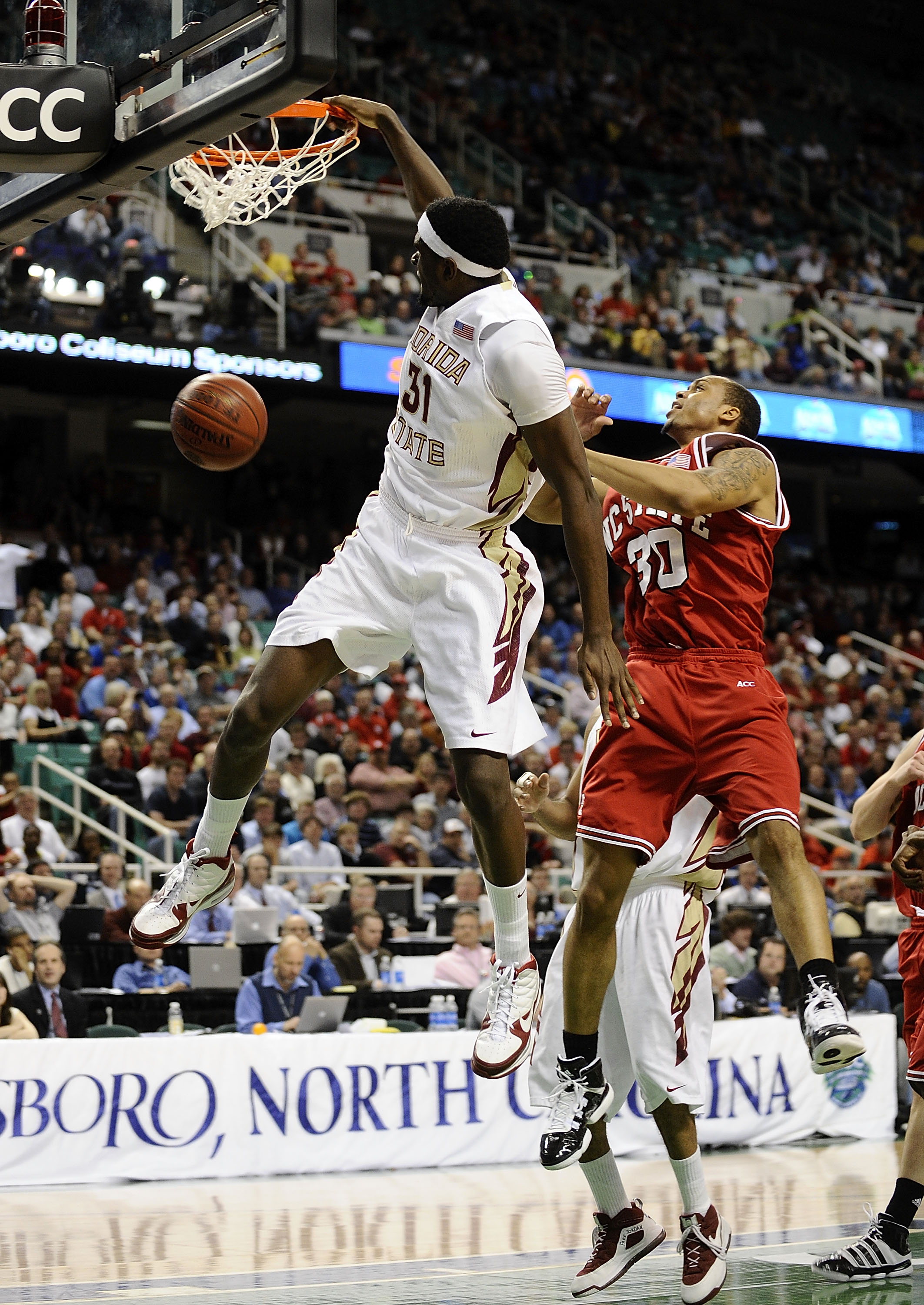 GREENSBORO, NC - MARCH 12:  Chris Singleton #31 of the Florida State Seminoles dunks in front of Johnny Thomas #30 of the North Carolina State Wolfpack in their quarterfinal game in the 2010 ACC Men's Basketball Tournament at the Greensboro Coliseum on Ma