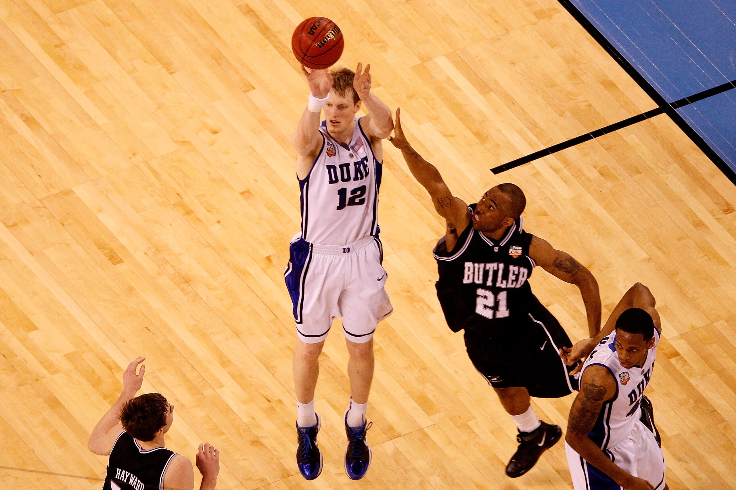 INDIANAPOLIS - APRIL 05:  Kyle Singler #12 of the Duke Blue Devils attempts a shot against Willie Veasley #21 of the Butler Bulldogs during the 2010 NCAA Division I Men's Basketball National Championship game at Lucas Oil Stadium on April 5, 2010 in India