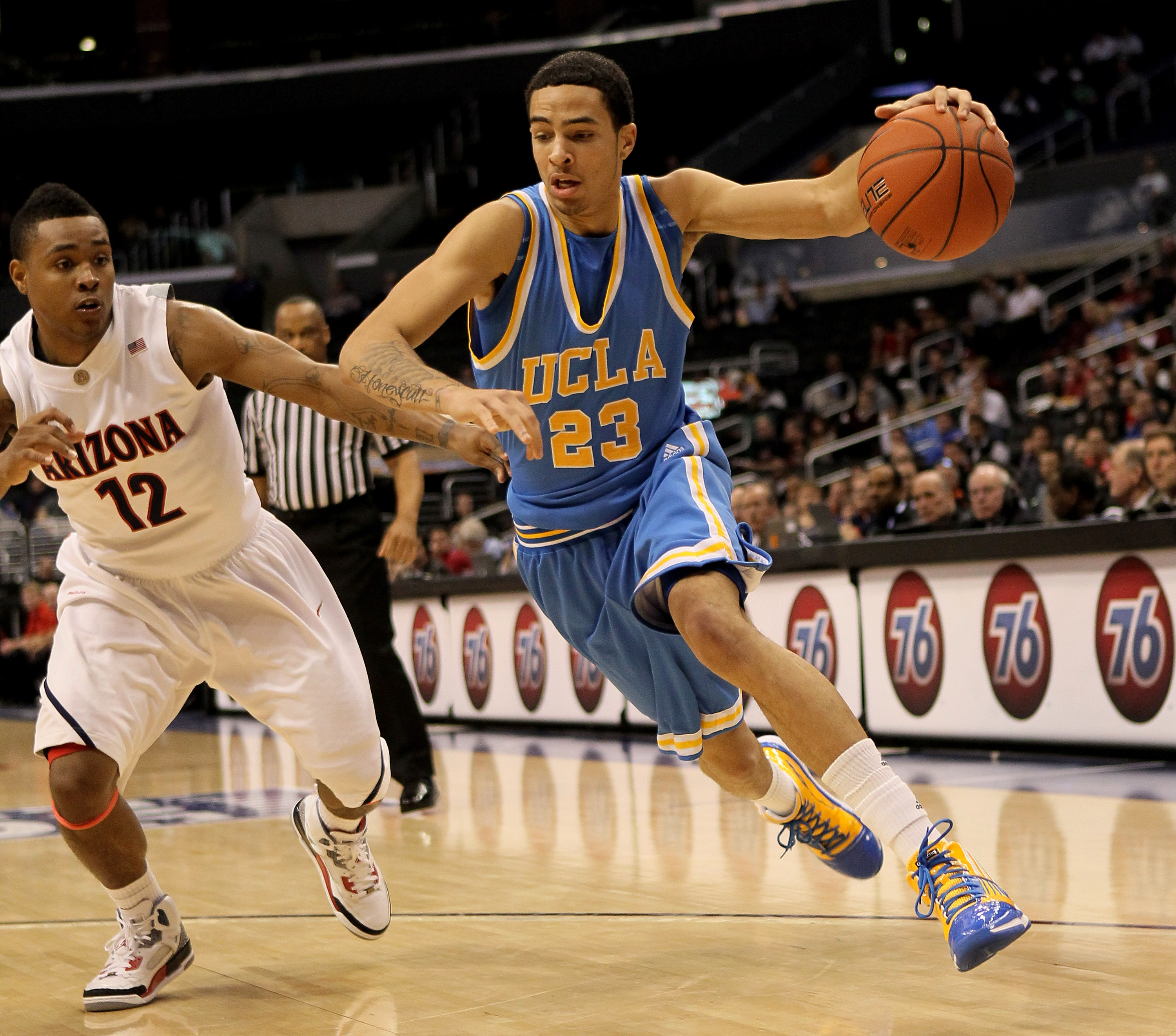 LOS ANGELES, CA - MARCH 11:  Tyler Honeycutt #23 of the UCLA Bruins drives around Lamont Jones #12 of the Arizona Wildcats during the quarterfinals of the Pac-10 Basketball Tournament at Staples Center on March 11, 2010 in Los Angeles, California. UCLA wo