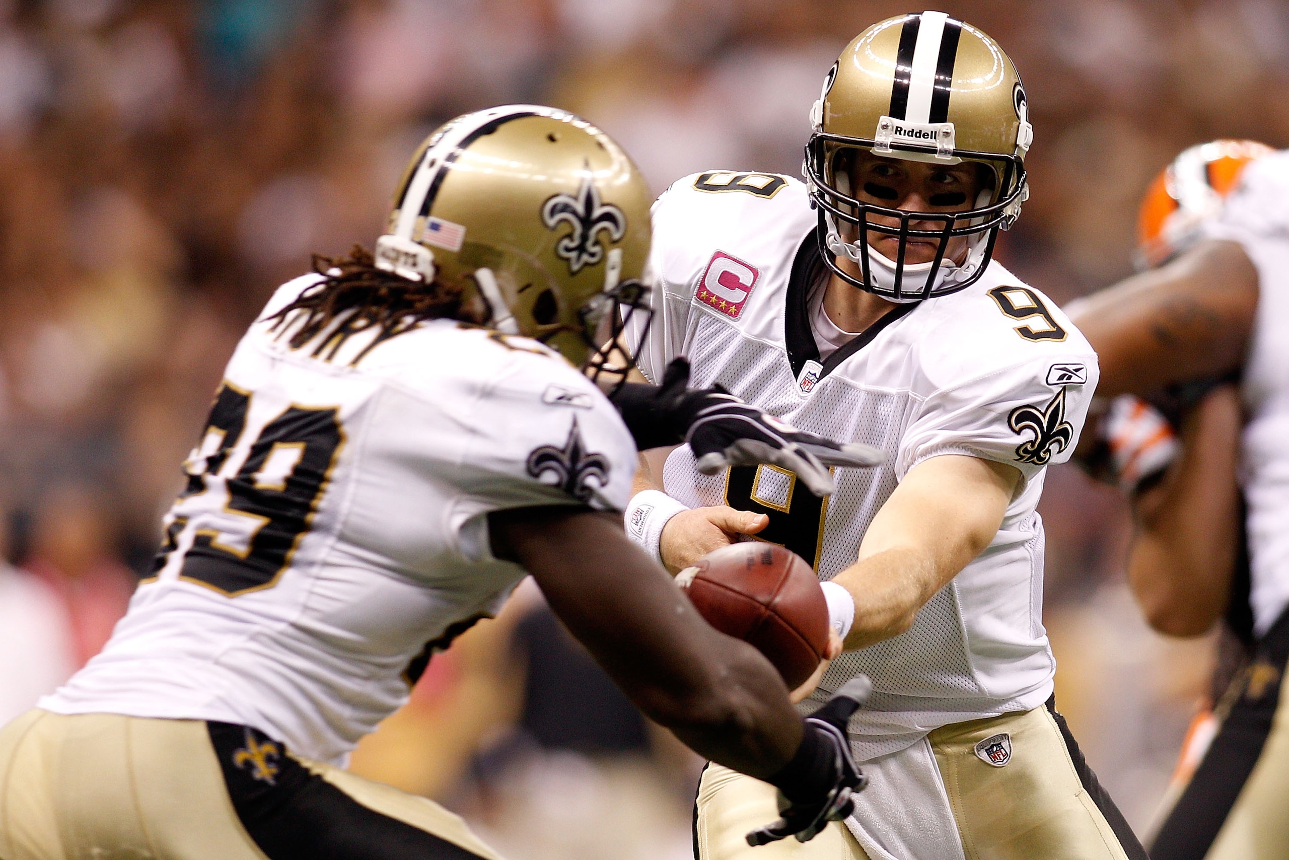 NEW ORLEANS - OCTOBER 24:  Drew Brees #9 hands off the ball to Chris Ivory #29 of the New Orleans Saints during the game against the Cleveland Browns at the Louisiana Superdome on October 24, 2010 in New Orleans, Louisiana.  The Browns defeated the Saints