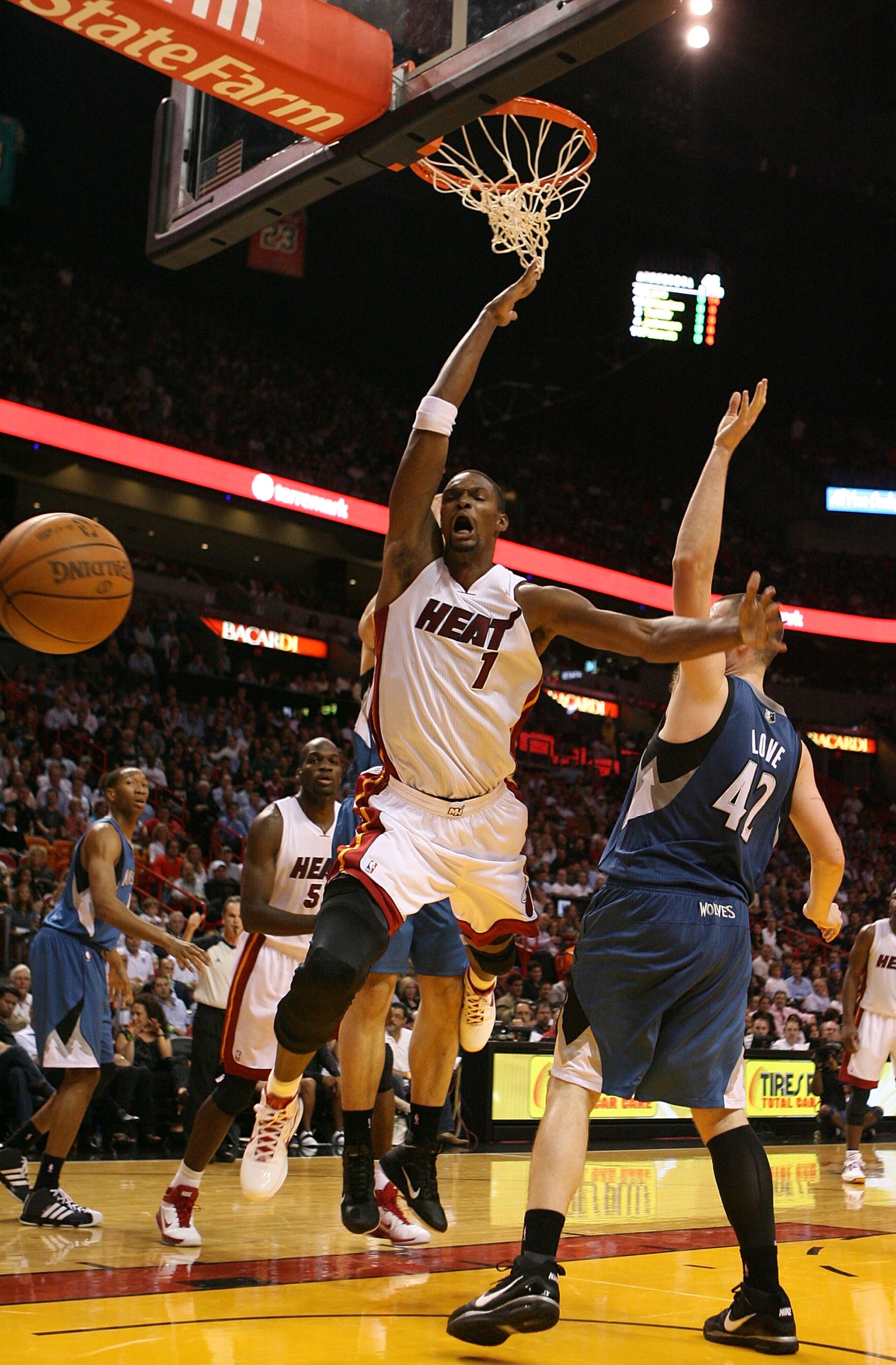 MIAMI - NOVEMBER 02: Forward Chris Bosh #1 of the Miami Heat shoots against center Kevin Love #42 of the Minnesota Wolves at American Airlines Arena on November 2, 2010 in Miami, Florida. NOTE TO USER: User expressly acknowledges and agrees that, by down MIAMI - NOVEMBER 02: Forward Chris Bosh #1 of the Miami Heat shoots against center Kevin Love #42 of the Minnesota Wolves at American Airlines Arena on November 2, 2010 in Miami, Florida. NOTE TO USER: User expressly acknowledges and agrees that, by down