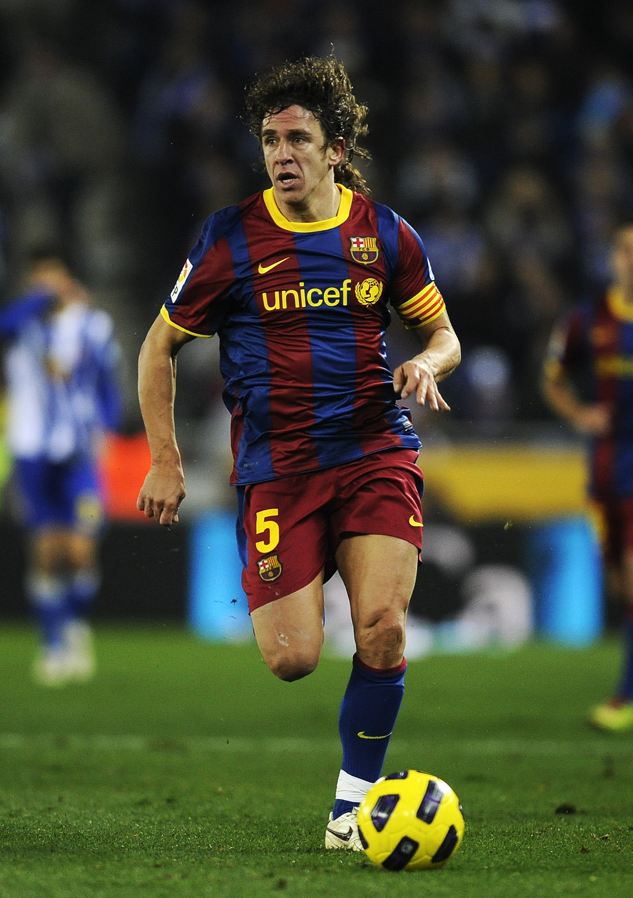 BARCELONA, SPAIN - DECEMBER 18:  Carles Puyol of Barcelona runs with the ball during the La Liga match between Espanyol and Barcelona at Cornella - El Prat stadium on December 18, 2010 in Barcelona, Spain. Barcelona won the match 1-5.  (Photo by David Ram