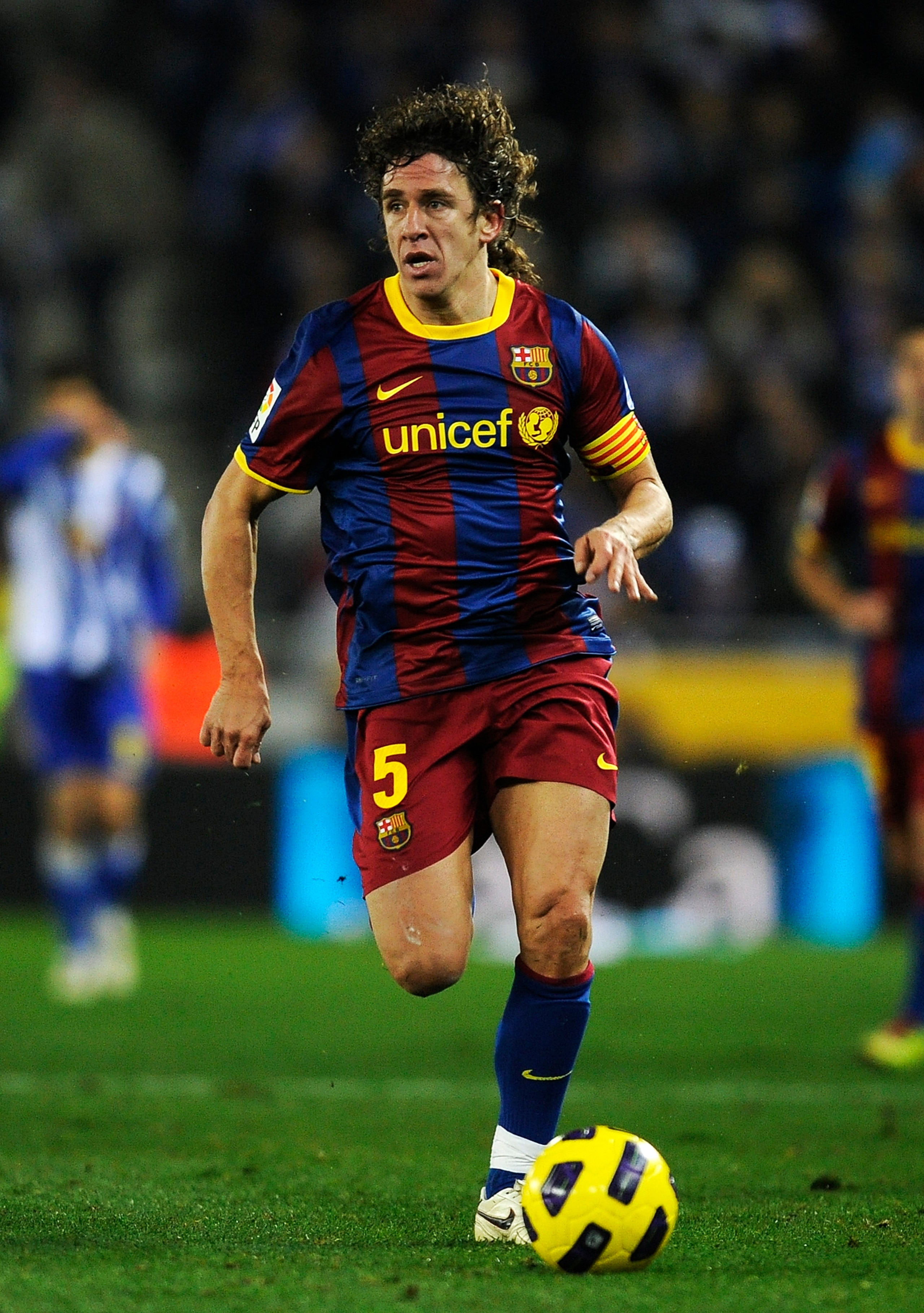 BARCELONA, SPAIN - DECEMBER 18:  Carles Puyol of Barcelona runs with the ball during the La Liga match between Espanyol and Barcelona at Cornella - El Prat stadium on December 18, 2010 in Barcelona, Spain. Barcelona won the match 1-5.  (Photo by David Ram