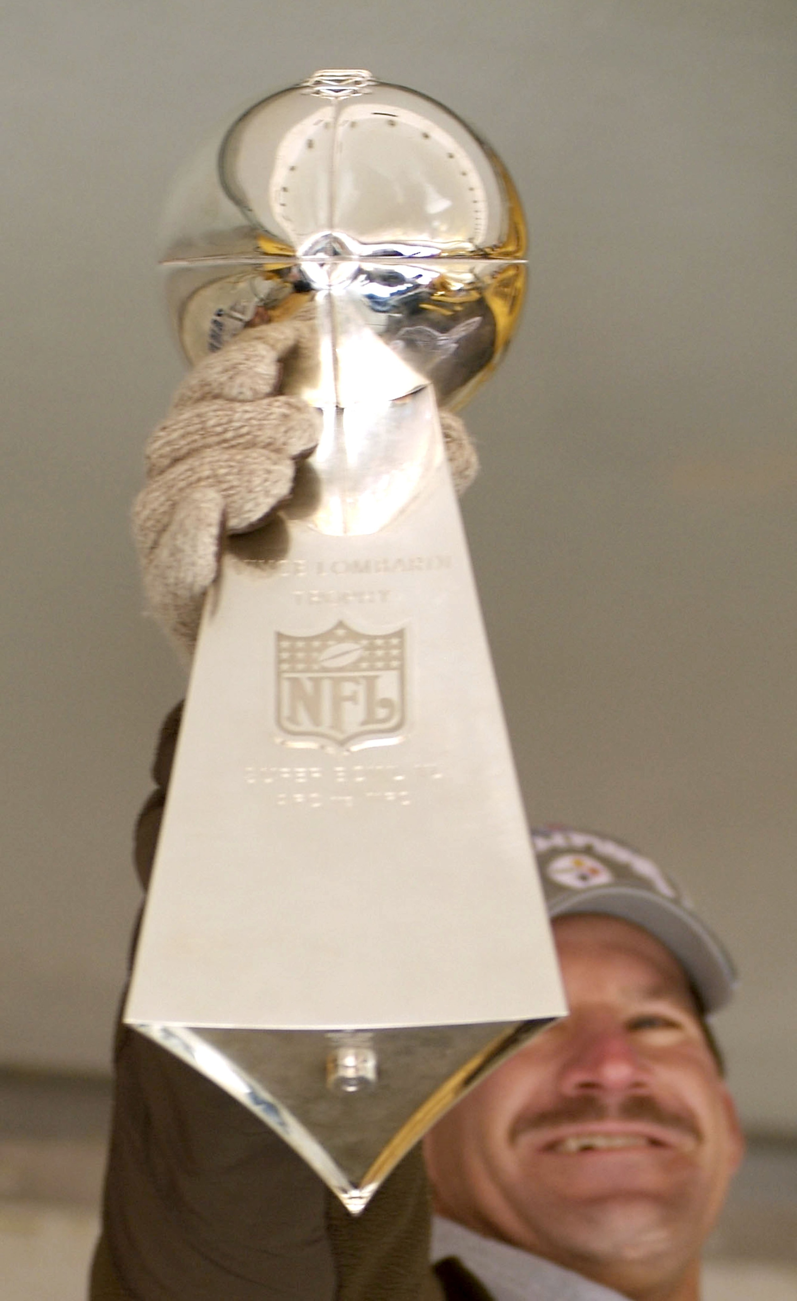 PITTSBURGH, PA - FEBRUARY 7:  Pittsburgh Steelers head coach Pittsburgh Steelers head coach Bill Cowher holds up the Vince Lombardi trophy to the crowd at the end of the victory parade celebrating winning Super Bowl XL February 7, 2006 in downtown Pittsbu