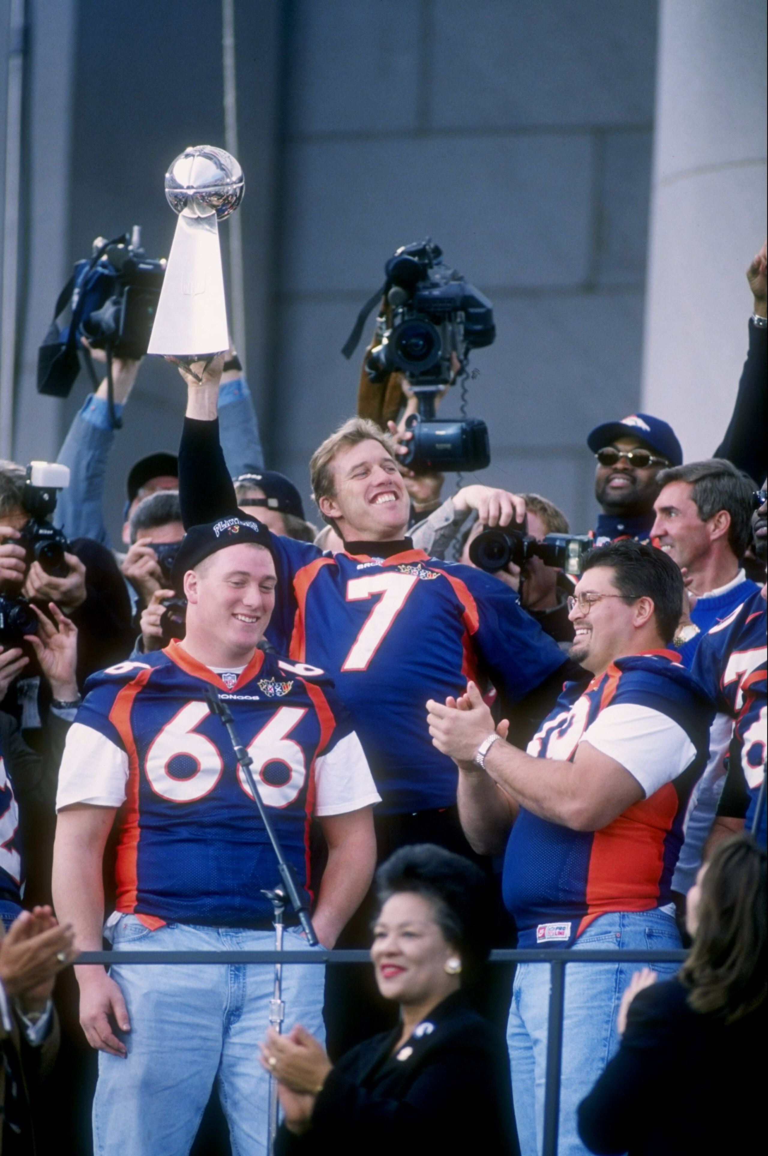 27 Jan 1998: John Elway and Tom Nalen #66 of the Denver Broncos celebrate while holding up the Lombardi Trophy during the Broncos Super Bowl XXXII victory parade in Denver Colorado. The Broncos defeated the Green Bay Packers 31-24 in Super Bowl XXXII in S